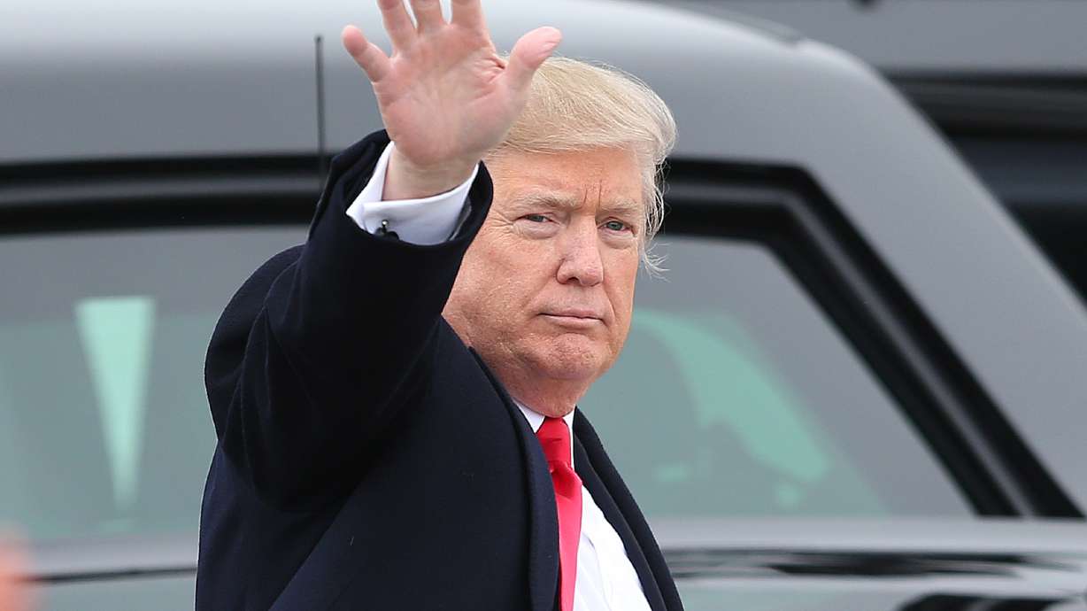 President Donald Trump waves to the crowd at Roland R. Wright Air National Guard Base at the Salt Lake City International Airport in Salt Lake City on Dec. 4, 2017.