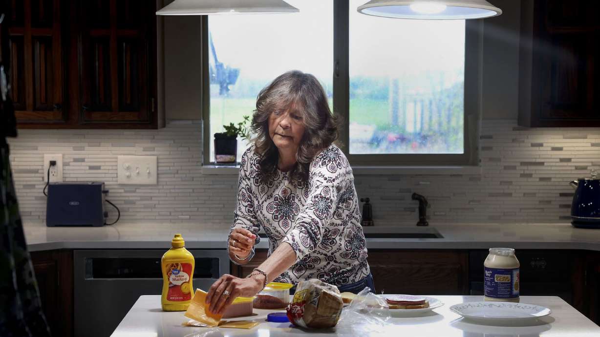 Lisa Conley makes a sandwich in her Marriott-Slaterville home on Friday. Conley favors removing Utah's state sales tax on food but not the Legislature's decision to link it to passage of constitutional amendment.