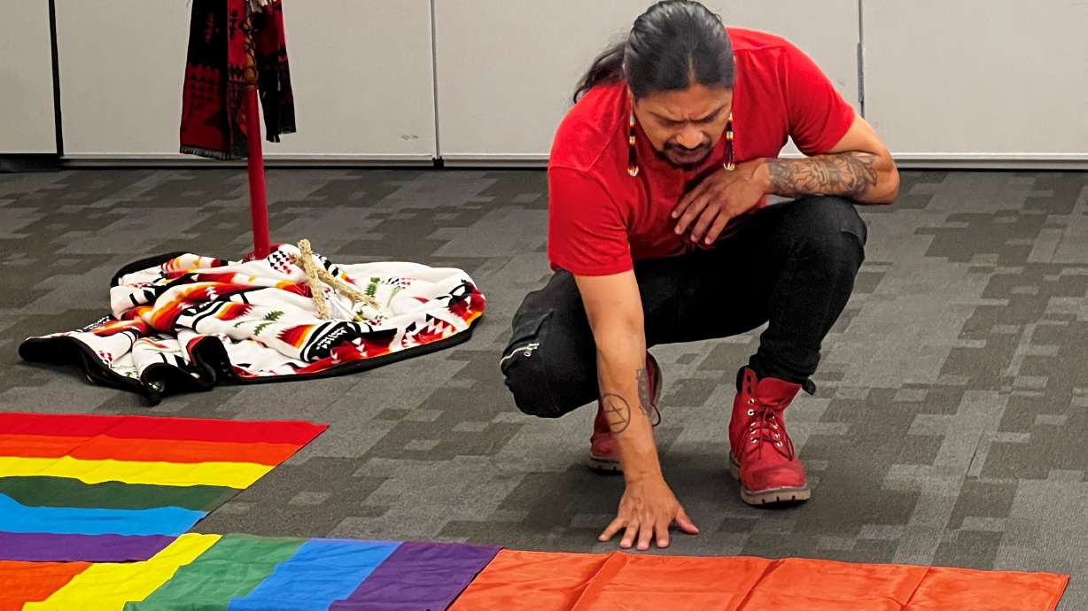 An attendee of the screening of the new documentary "Missing Murdered Unheard" about crimes against Indigenous people looks at a display on Friday at the Utah Cultural Center in West Valley City.