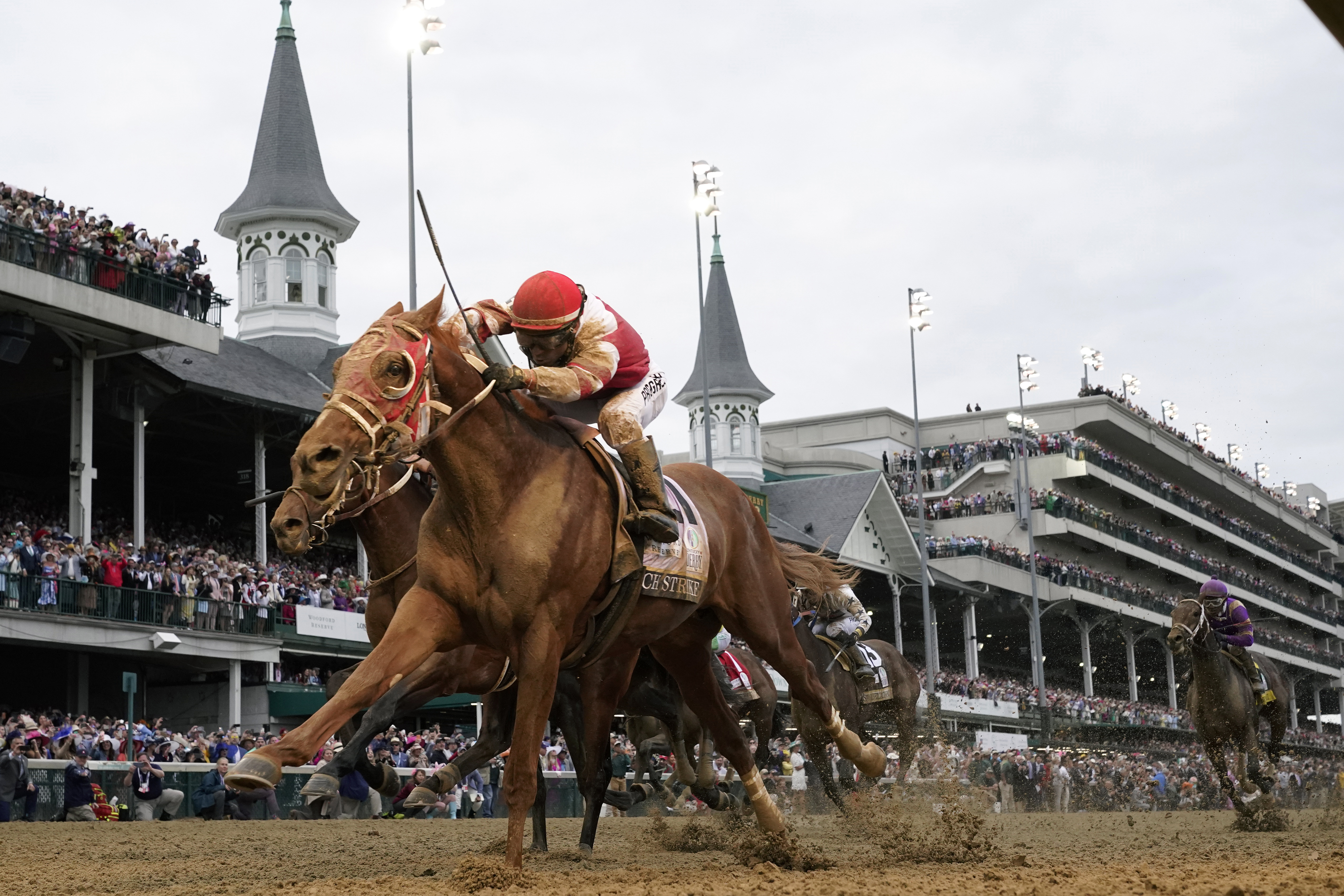 FILE - Rich Strike, with Sonny Leon aboard, crosses the finish line to win the 148th running of the Kentucky Derby horse race at Churchill Downs Saturday, May 7, 2022, in Louisville, Ky. Rich Strike's stunning upset victory in last year's Kentucky Derby as a nearly 81-1 long shot provided the race's second biggest odds winner in four years. 