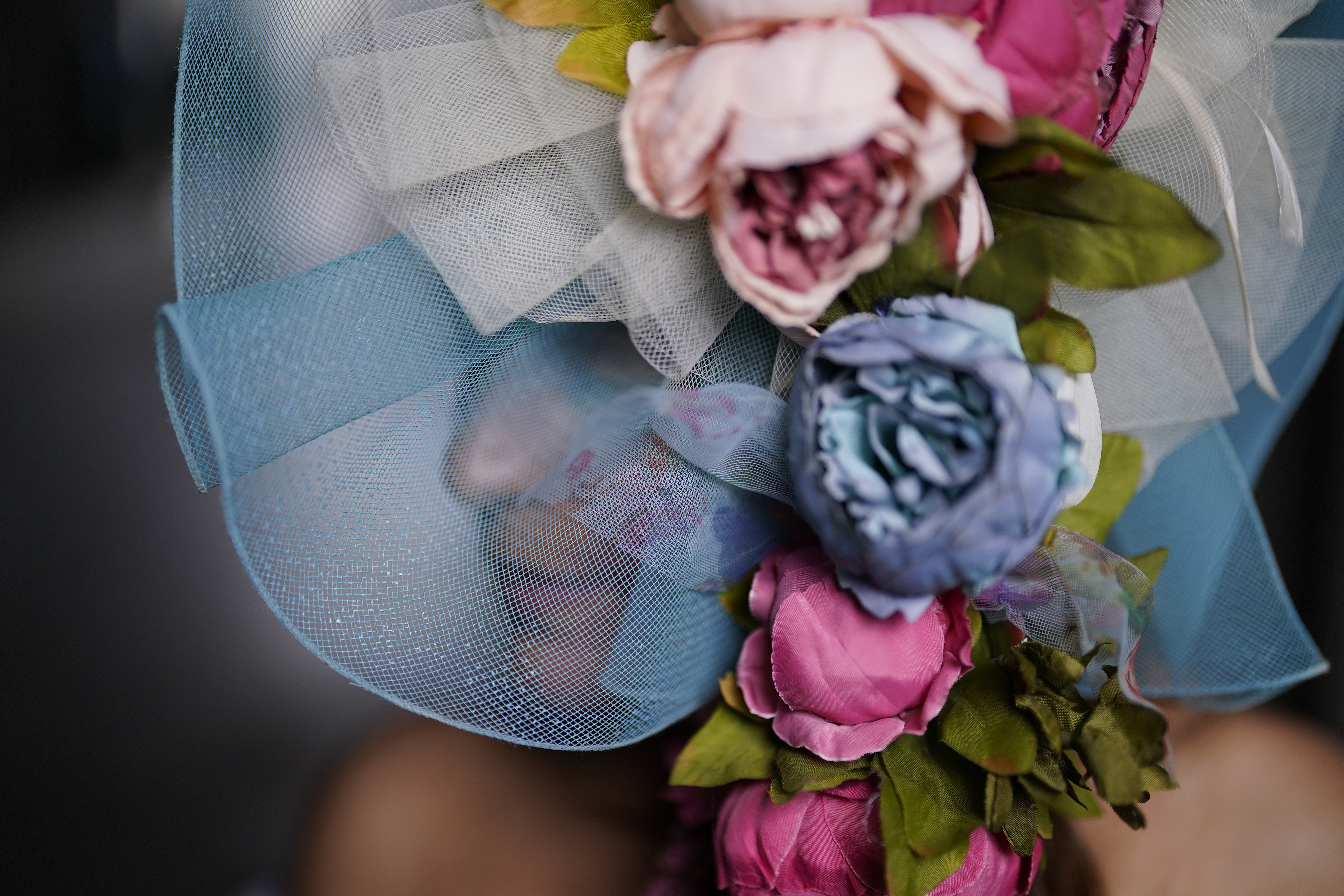 A race fan walks on the grounds of Churchill Downs before the 149th running of the Kentucky Derby horse race, Saturday, May 6, 2023, in Louisville, Ky. 