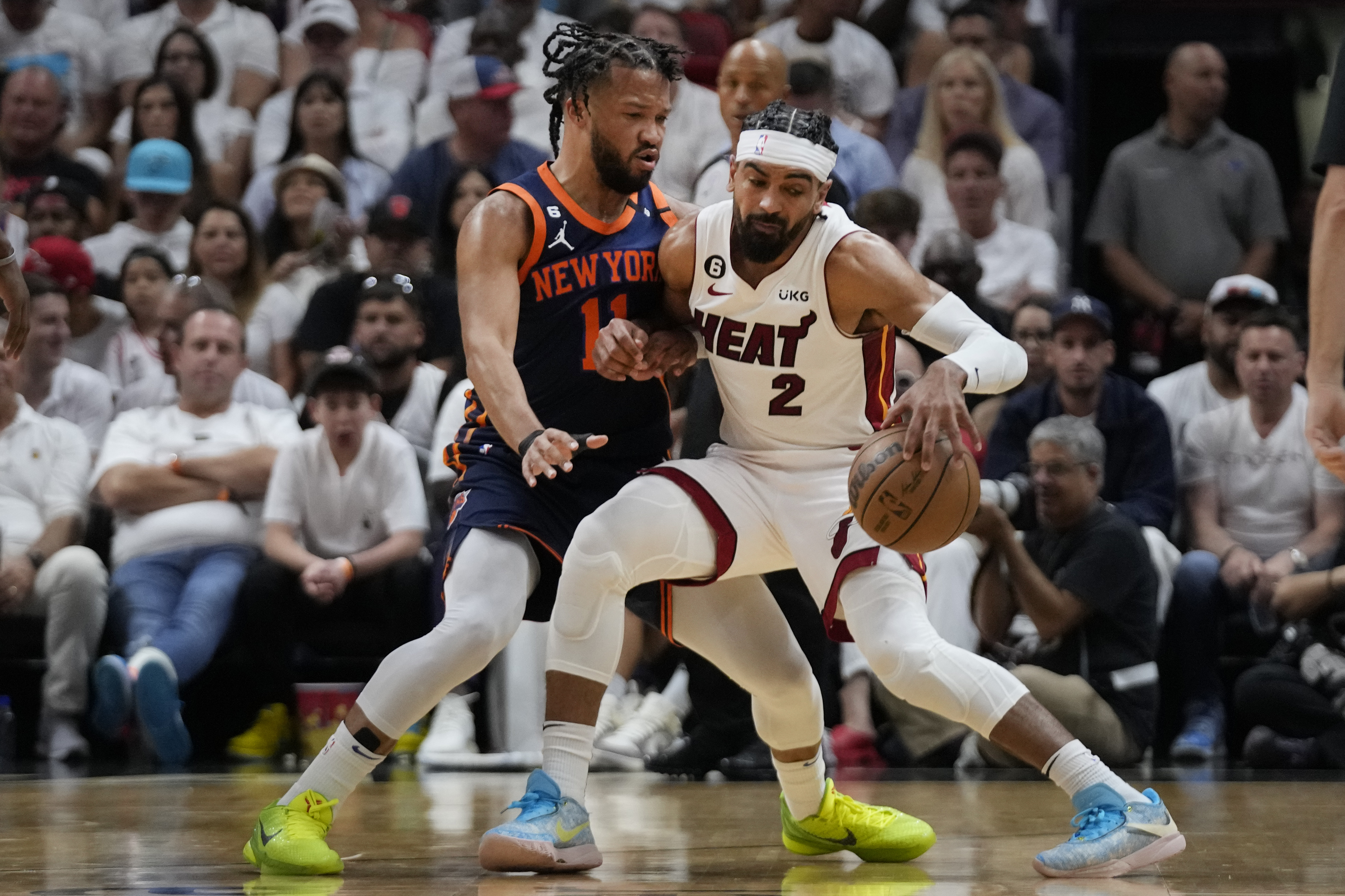 Miami Heat guard Gabe Vincent (2) drives up against New York Knicks guard Jalen Brunson (11) during the first half of Game 3 of an NBA basketball second-round playoff series, Saturday, May 6, 2023, in Miami. 