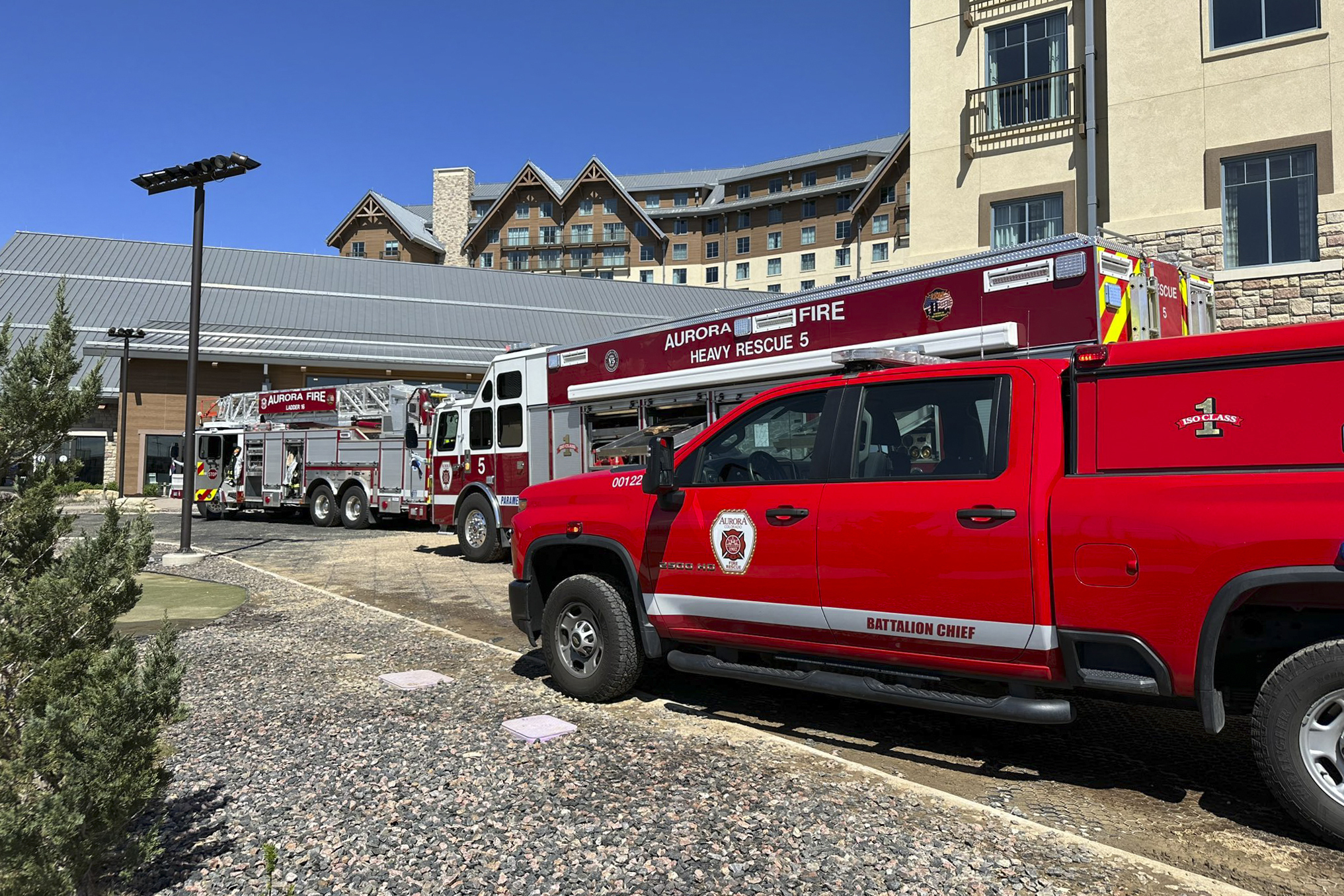 This photo provided by Aurora Fire Rescue shows firetrucks parked outside Gaylord Rockies resort on Saturday in Aurora, Colo. Six people were hurt, two critically, when part of a heating and ventilation system collapsed at the resort pool in Colorado.
