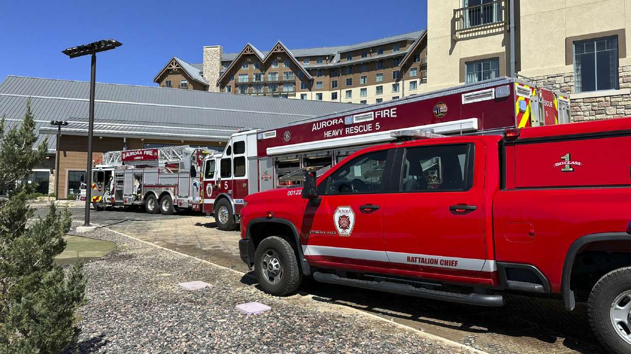 This photo provided by Aurora Fire Rescue shows firetrucks parked outside Gaylord Rockies resort on Saturday in Aurora, Colo. Six people were hurt, two critically, when part of a heating and ventilation system collapsed at the resort pool in Colorado.
