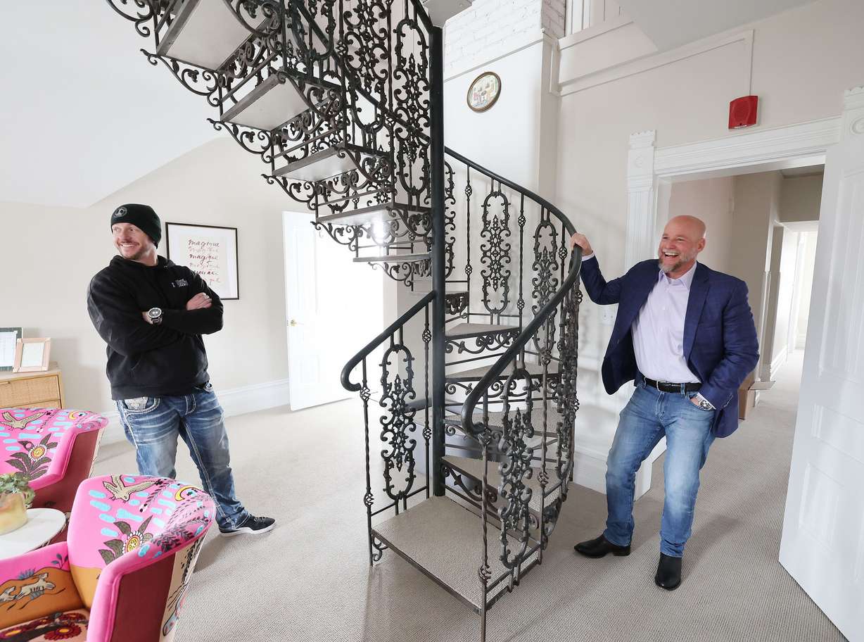Dave Durocher, executive director of The Other Side Academy, right, talks with Jordan Holdaway, general manager of Other Side Academy Builders, during renovation of the Armstrong Mansion in Salt Lake City on March 29. The organization works with former prisoners hoping to rehabilitate their lives.