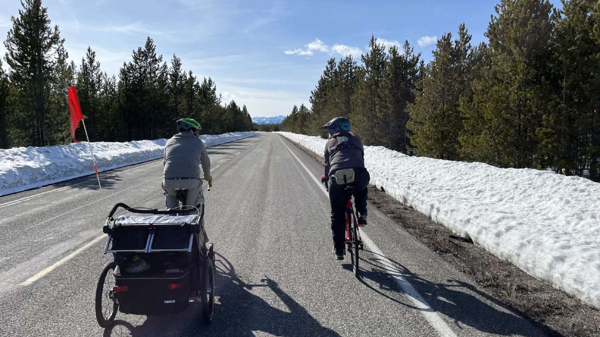 Heath and Miriam Druzin ride their bicycles into Yellowstone National Park in April shortly before the main roads opened to cars.