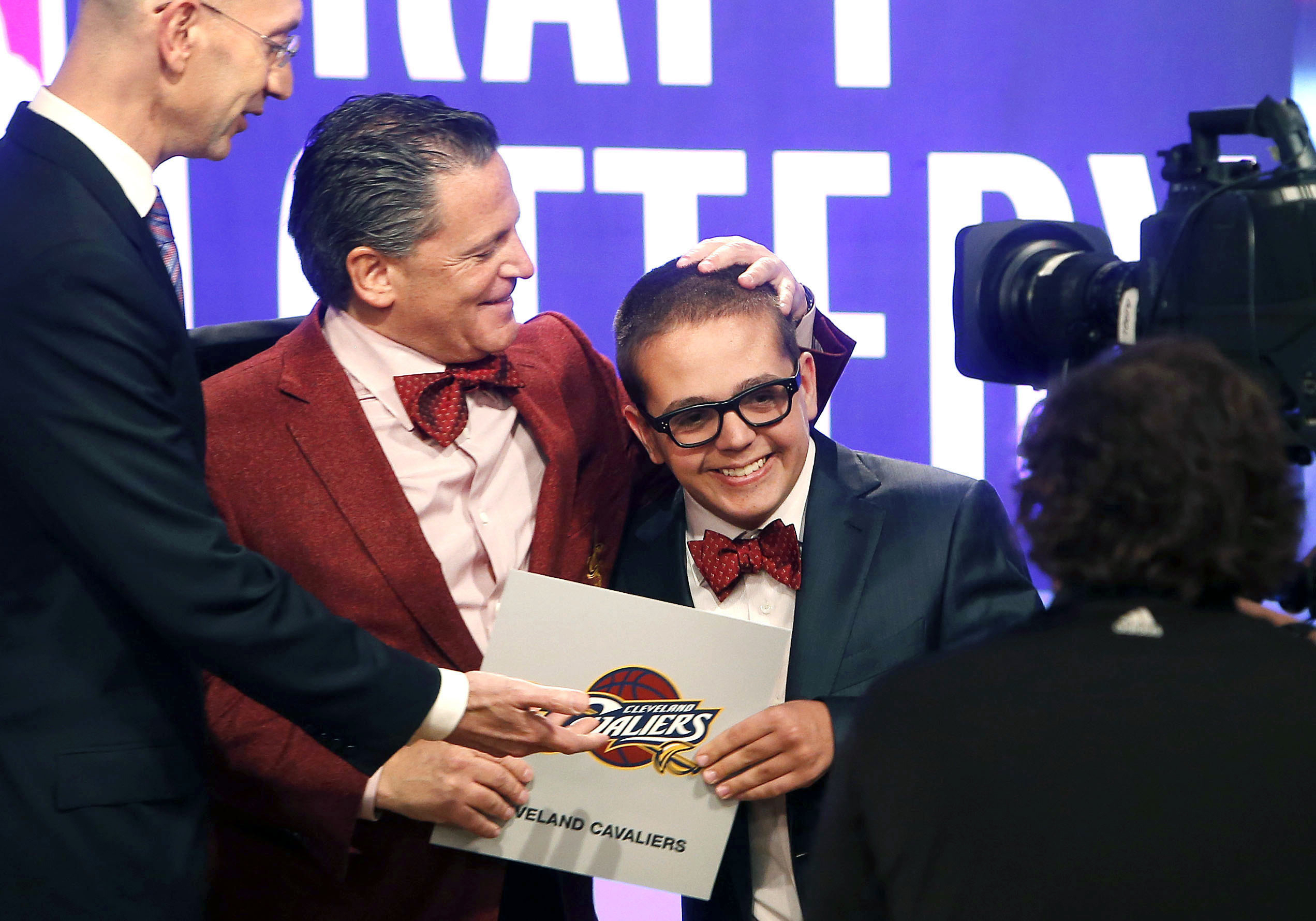 FILE - In this May 21, 2013, file photo, Cleveland Cavaliers owner Dan Gilbert congratulates his son, Nick Gilbert, after the team won the NBA basketball draft lottery in New York. Nicolas “Nick” Gilbert, who became the team's good luck charm at NBA draft lotteries, has died. He was 26. A funeral announcement posted by the Ira Kaufman Chapel said Gilbert died Saturday, May 6, 2023 “peacefully at home surrounded by family.” 