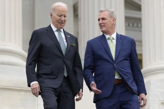 President Joe Biden talks with House Speaker Kevin McCarthy, R-Calif., as they walk down the House steps as they leave after attending an annual St. Patrick's Day luncheon gathering at the Capitol in Washington, March 17. The Tuesday White House sitdown between the president and congressional leaders will be the first substantive talks between Biden and McCarthy in months.