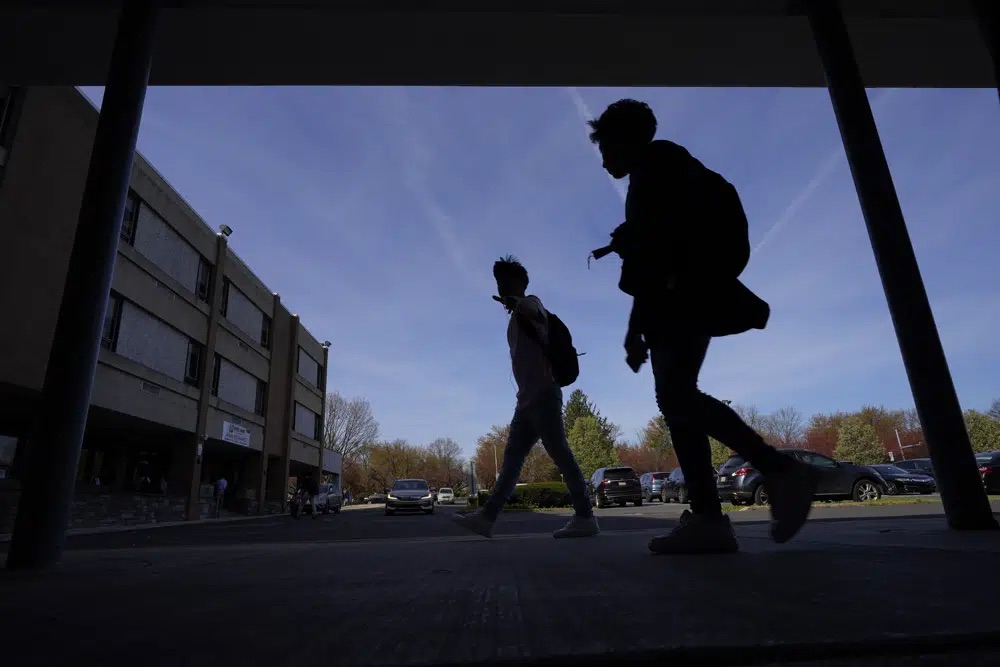 Students walk outside Upper Darby High School, April 12 in Drexel Hill, Pa. For some schools, the pandemic allowed experimentation to try new schedules. Large school systems including Denver, Philadelphia and Anchorage, Alaska, have been looking into later start times.