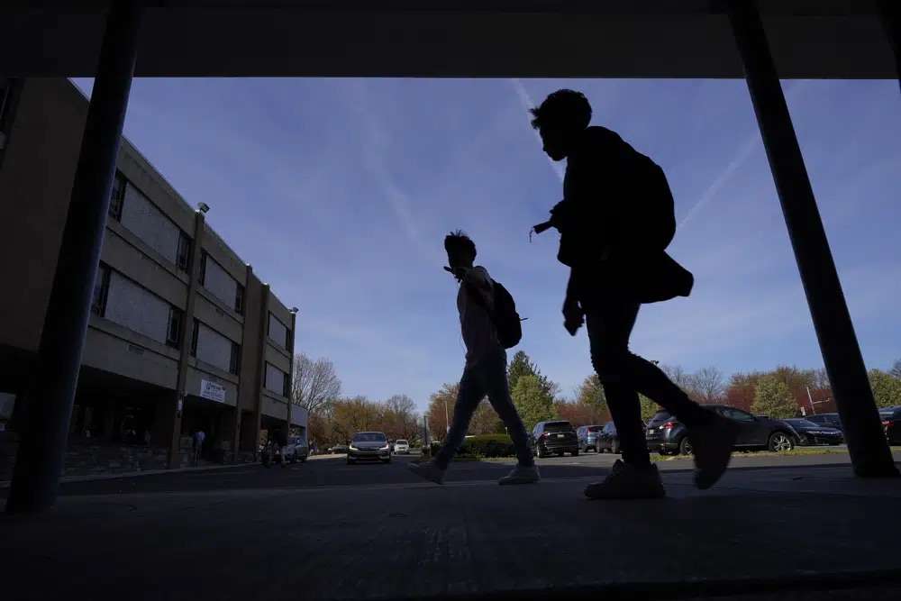 Students walk outside Upper Darby High School, April 12 in Drexel Hill, Pa. For some schools, the pandemic allowed experimentation to try new schedules. Large school systems including Denver, Philadelphia and Anchorage, Alaska, have been looking into later start times.
