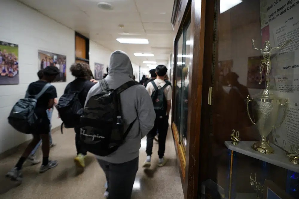Students walk through Upper Darby High School, April 12, in Drexel Hill, Pa. For some schools, the pandemic allowed experimentation to try new schedules. Large school systems including Denver, Philadelphia and Anchorage, Alaska, have been looking into later start times.
