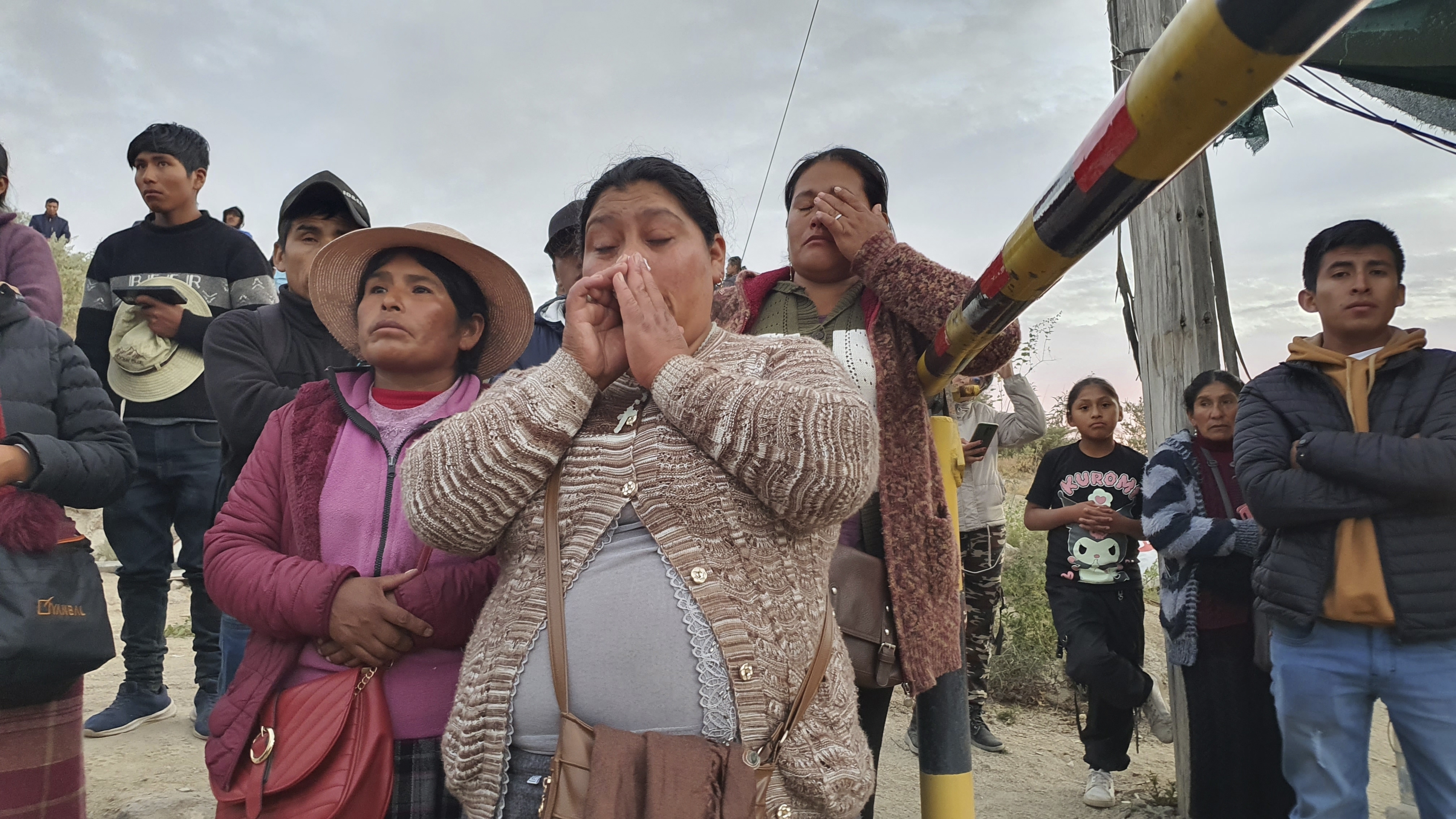 Relatives of trapped miners wait outside a gold mine in Arequipa, Peru, Sunday. The Public Ministry confirmed the death of 27 miners, who were trapped early Saturday morning due to an explosion in a tunnel.