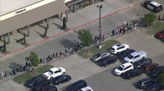 In this frame grab from video provided by WFAA, people are evacuated from Allen Premium Outlet, Saturday, in Allen, Texas. Law enforcement responded to reports of a shooting at the outlet mall, in the Dallas area.