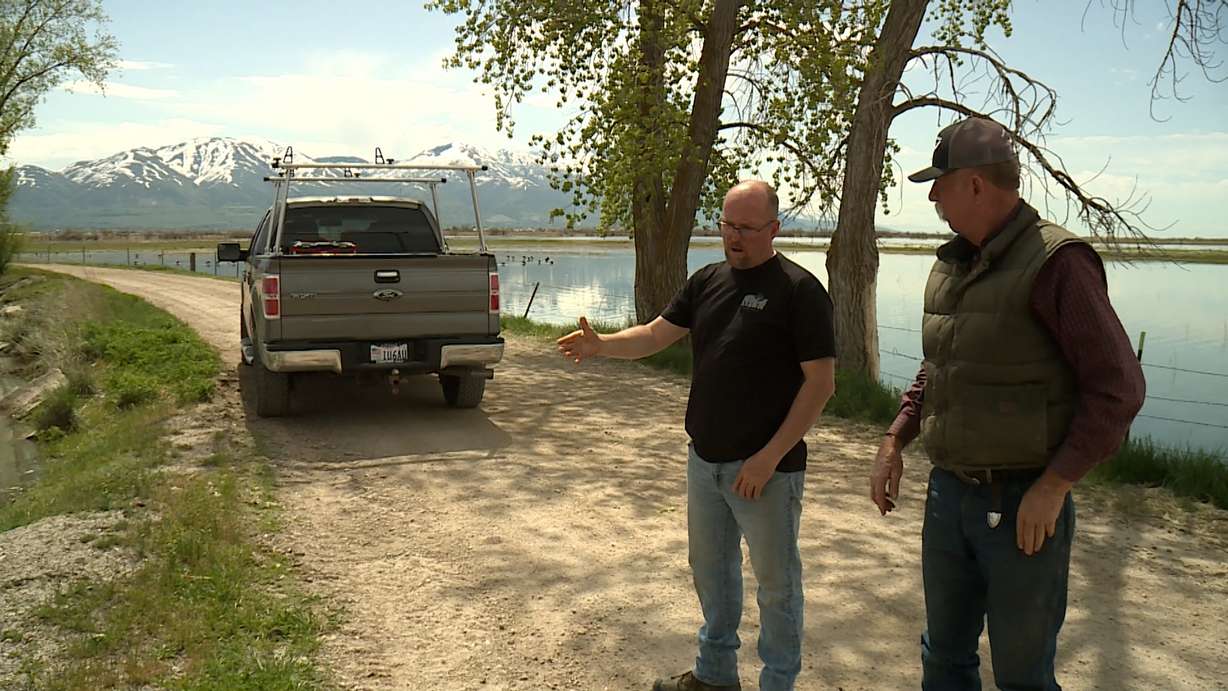 Corinne Mayor Shane Baton and Lyle Clark are shown Monday in Box Elder County as the Bear River continues to rise.