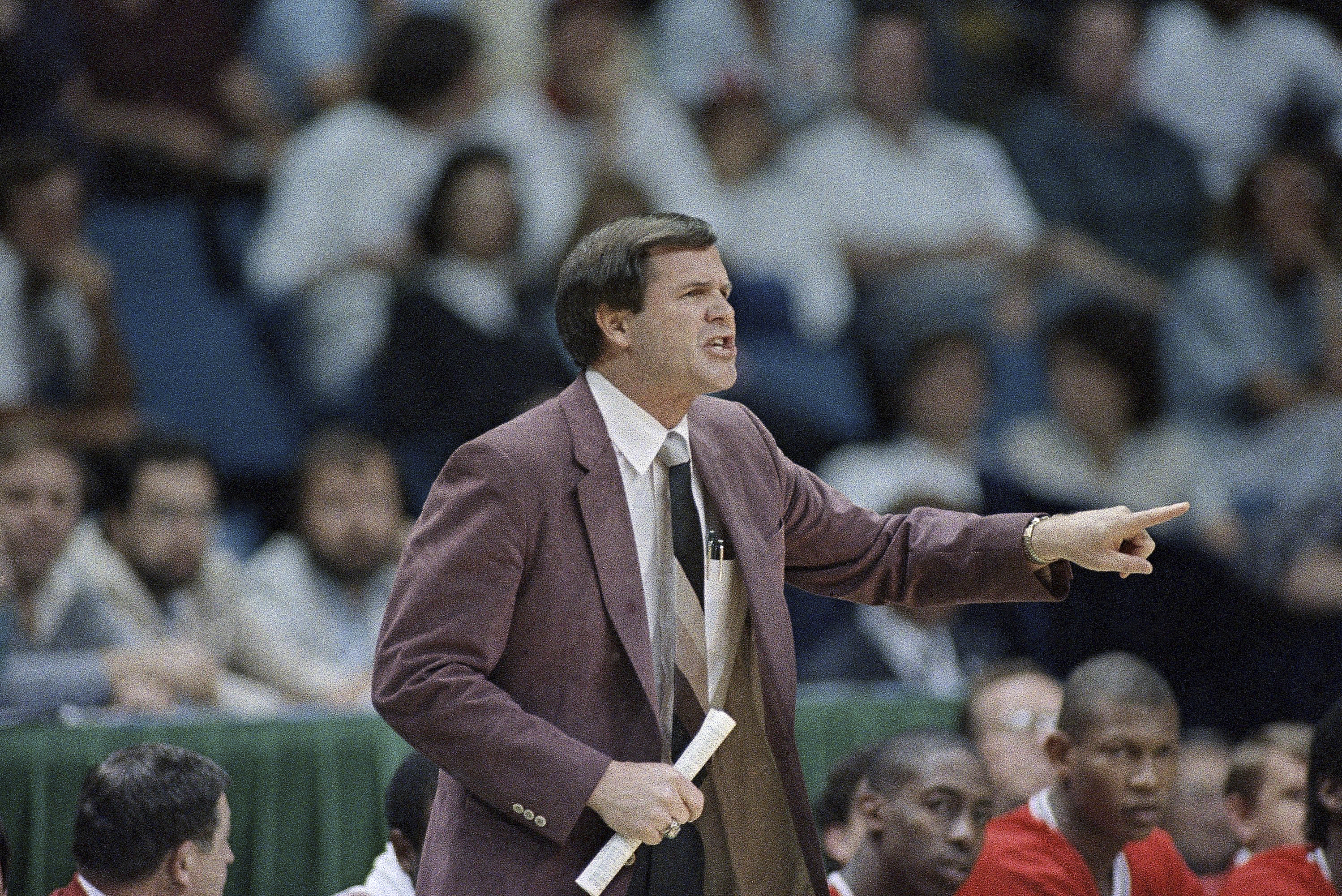 FILE - Louisville coach Denny Crum yells from the sideline during the first half of an NCAA college basketball semifinal game against LSU at Reunion Arena, Saturday, March 29, 1986, Dallas, Texas. Denny Crum, who won two NCAA men’s basketball championships and built Louisville into one of the 1980s’ dominant programs during a Hall of Fame coaching career, died Tuesday, May 9, 2023. He was 86. 