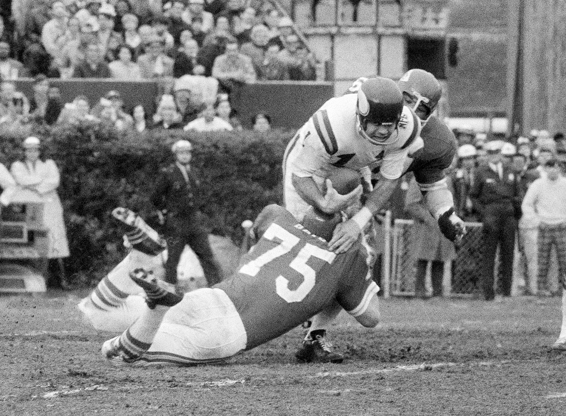 FILE - Minnesota Vikings quarterback Joe Kapp is hauled down by Kansas City Chiefs' Jerry Mays (75) as another Chiefs player moves in from the rear during the first half of the Super Bowl IV football game in New Orleans, Jan. 11, 1970. Kapp, the tough quarterback who led the Minnesota Vikings to their first Super Bowl and California to its last Rose Bowl, has died. He was 85. Cal confirmed that Kapp died on Monday, May 8, 2023. 