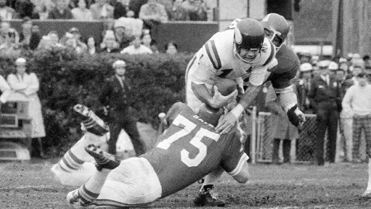 FILE - Minnesota Vikings quarterback Joe Kapp is hauled down by Kansas City Chiefs' Jerry Mays (75) as another Chiefs player moves in from the rear during the first half of the Super Bowl IV football game in New Orleans, Jan. 11, 1970. Kapp, the tough quarterback who led the Minnesota Vikings to their first Super Bowl and California to its last Rose Bowl, has died. He was 85. Cal confirmed that Kapp died on Monday, May 8, 2023.