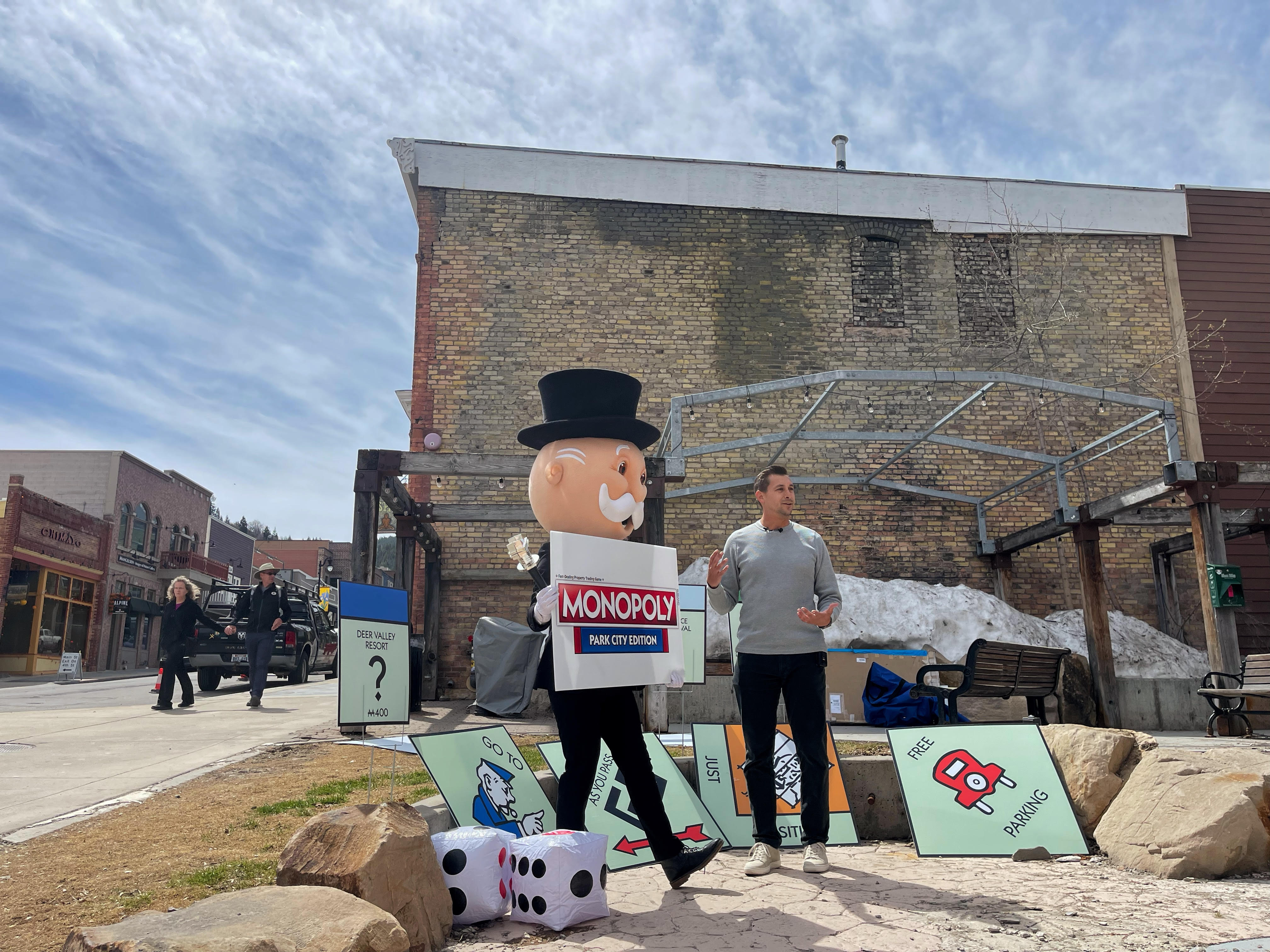 Rich Uncle Pennybags, also known as Mr. Monopoly, left, listens to Aaron Green, sales representative with Top Trumps USA, explain why Park City was chosen as the next special edition of Monopoly.