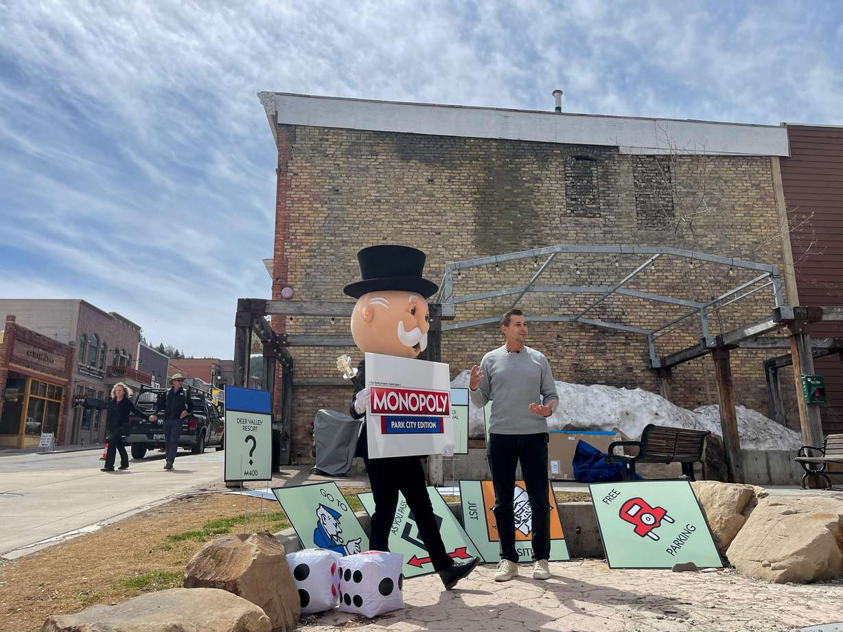 Rich Uncle Pennybags, also known as Mr. Monopoly, left, listens to Aaron Green, sales representative with Top Trumps USA, explain why Park City was chosen as the next special edition of Monopoly.