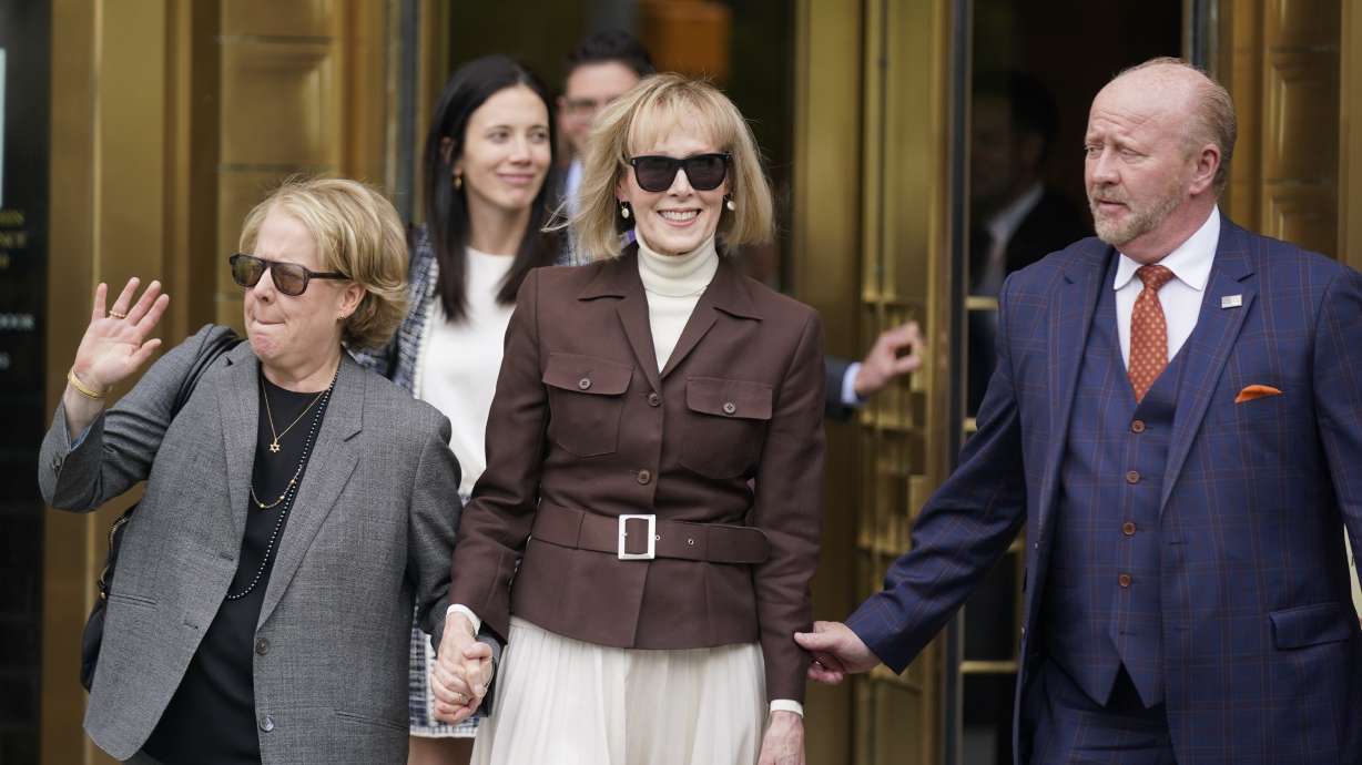 E. Jean Carroll, center, walks out of Manhattan federal court Tuesday in New York. A jury has found Donald Trump liable for sexually abusing the advice columnist in 1996, awarding her $5 million in a judgment.