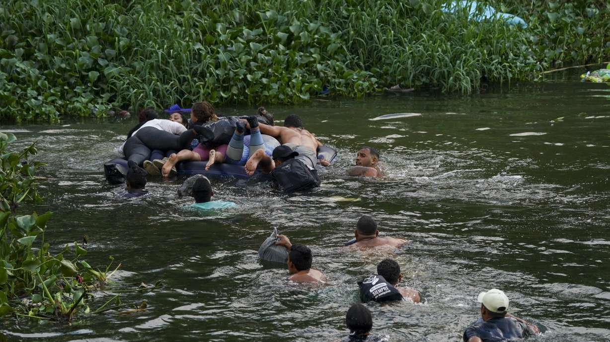 Migrants cross the Rio Bravo into the United States from Matamoros, Mexico, Tuesday. The U.S. is preparing for the Thursday end of the Title 42 policy, linked to the coronavirus pandemic, that allowed it to quickly expel many migrants seeking asylum.