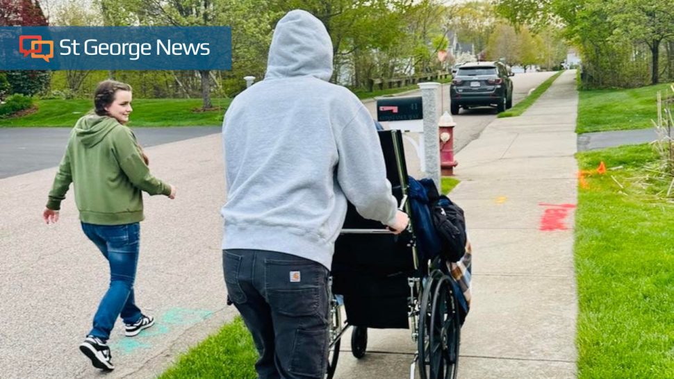 Sway Leonard (left) and Cross Leonard (pushing wheelchair) accompany their older brother home from the hospital in North Attleboro, Mass., May 3. Creed Leonard, 20, was critically injured when he was hit by a vehicle in the Boston area last fall.