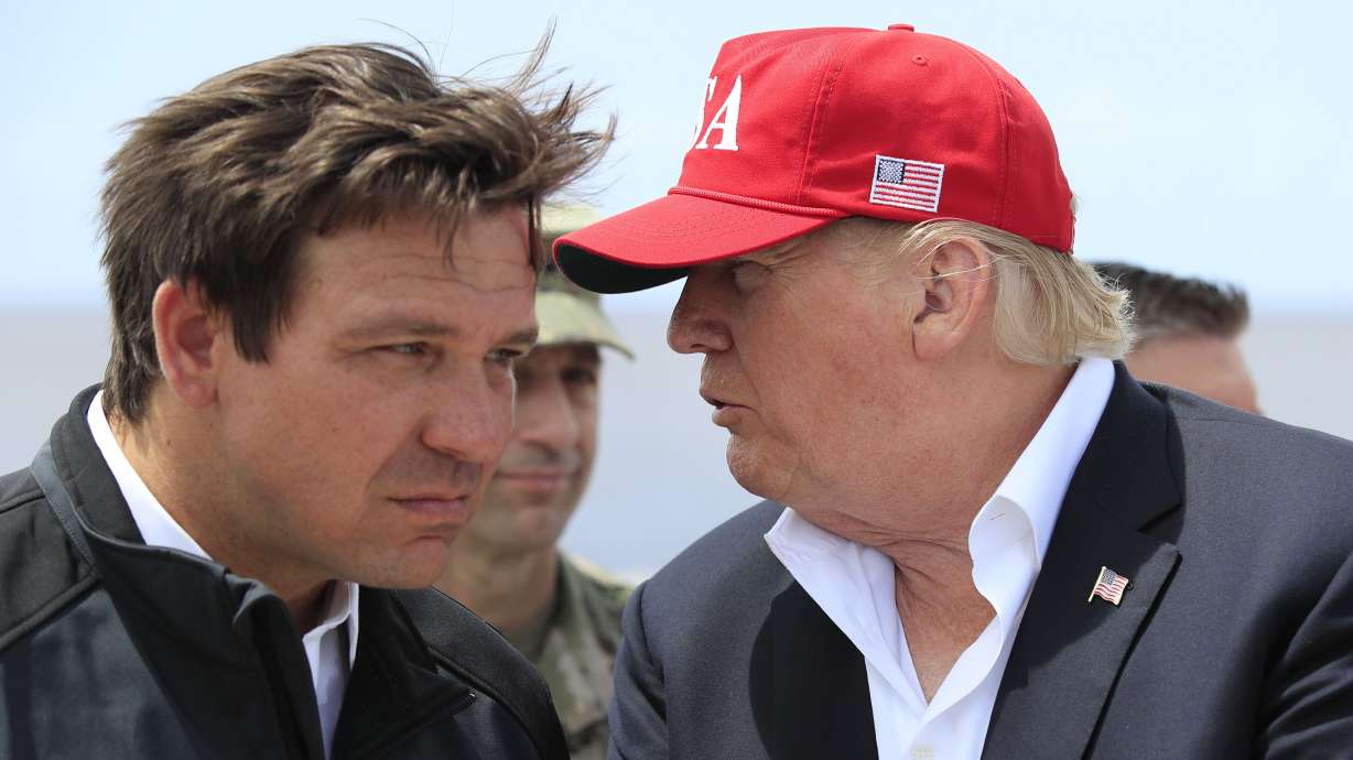 Former President Donald Trump talks to Florida Gov. Ron DeSantis, left, during a visit to Lake Okeechobee and Herbert Hoover Dike at Canal Point, Fla., March 29, 2019. The two are seen as GOP presidential frontrunners for 2024.