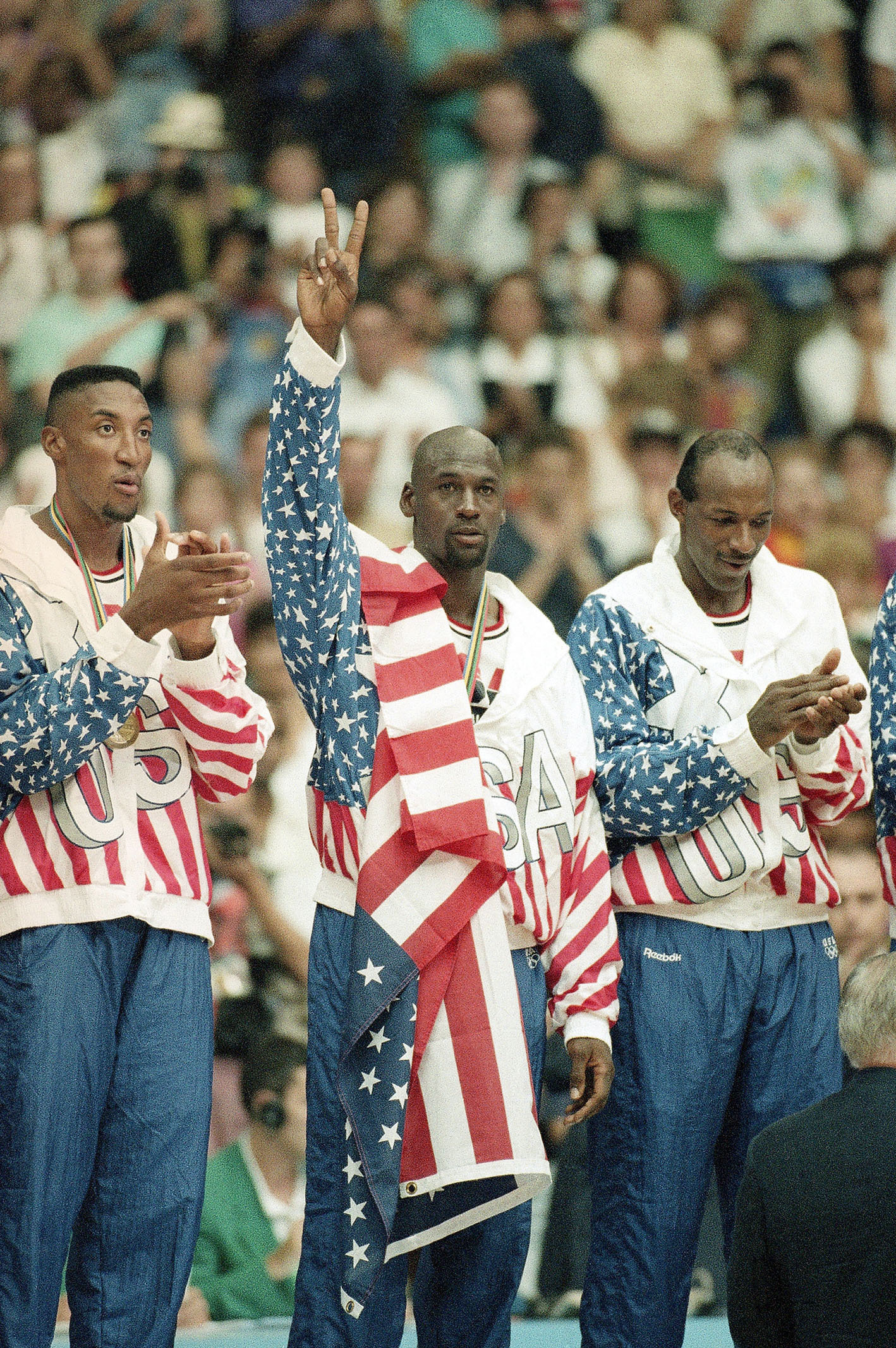 FILE - United States' Scottie Pippen, left, Michael Jorden, center, and Clyde Drexler rejoice, Aug. 8, 1992, with their gold medals after beating Croatia, 117-85, in Olympic basketball in Barcelona, Spain. The jacket that Jordan famously wore but covered the Reebok logo of at the 1992 Barcelona Olympics will be offered at auction by Sotheby's in June 2023. 