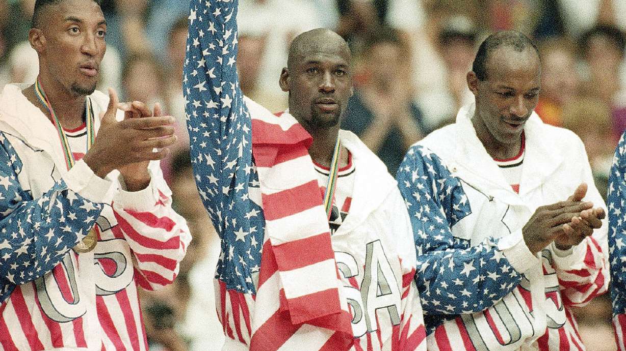 FILE - United States' Scottie Pippen, left, Michael Jorden, center, and Clyde Drexler rejoice, Aug. 8, 1992, with their gold medals after beating Croatia, 117-85, in Olympic basketball in Barcelona, Spain. The jacket that Jordan famously wore but covered the Reebok logo of at the 1992 Barcelona Olympics will be offered at auction by Sotheby's in June 2023.