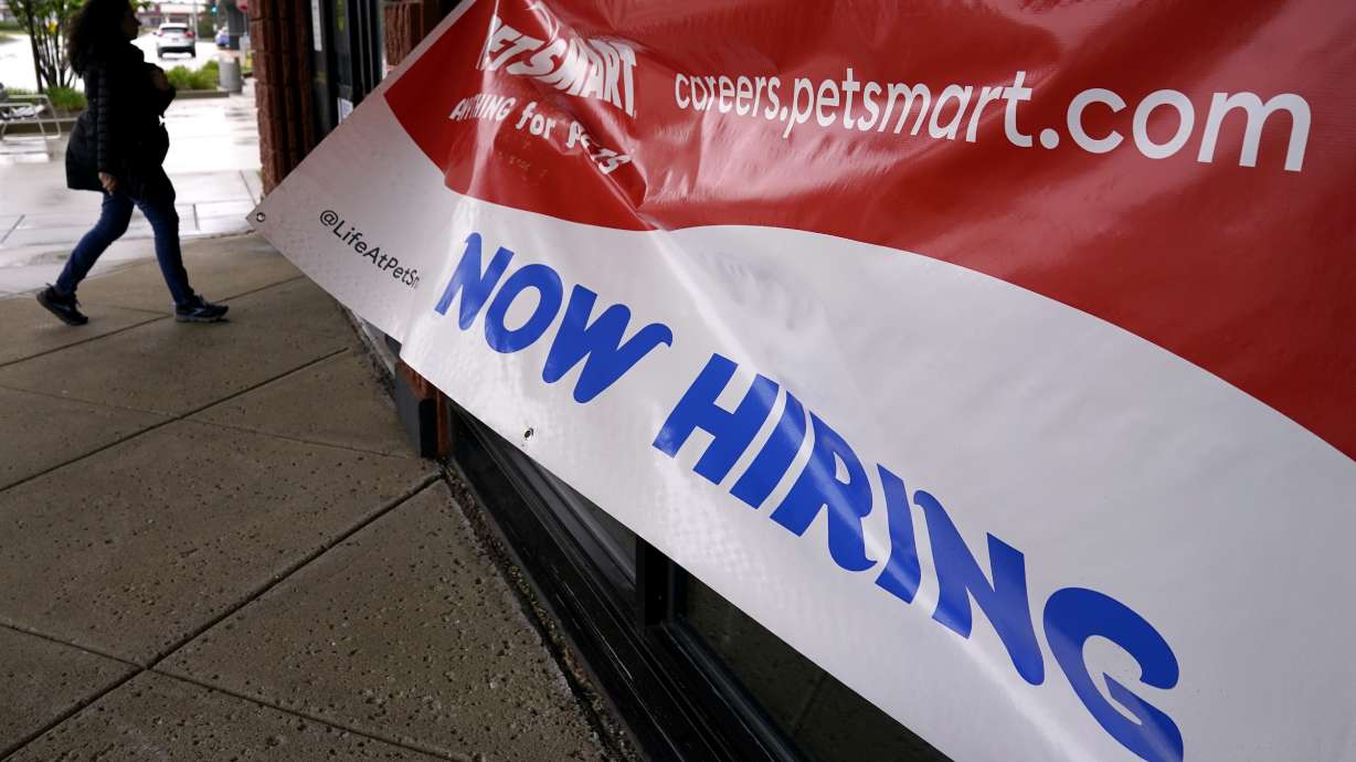 A hiring sign is displayed at a retail store in Downers Grove, Ill., May 1. The Labor Department reported Thursday that applications for unemployment benefits for the week ending May 6 rose by 22,000 to 264,000.