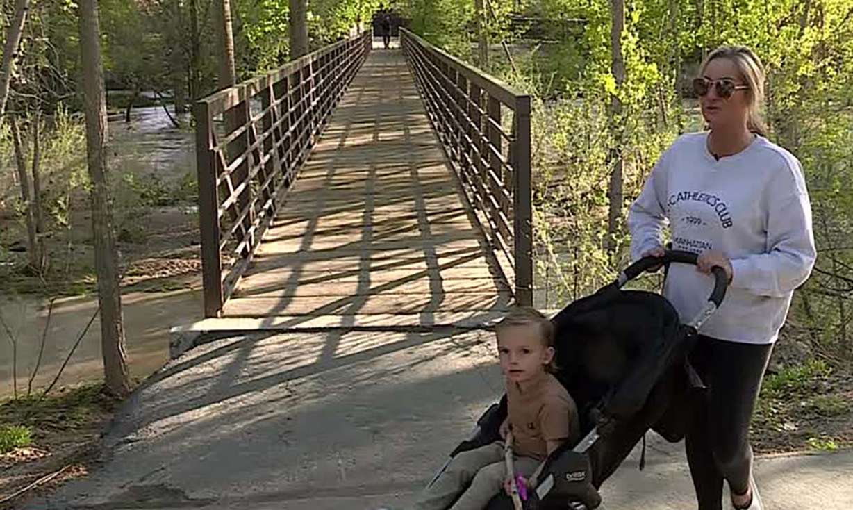 Stacey Stone talks to KSL Wednesday along a trail next to the Spanish Fork River. She said she's never witnessed the waters as swift and deep as they've been recently.