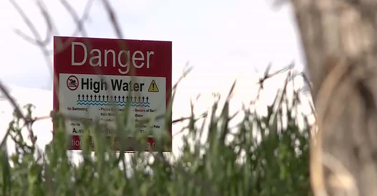 A sign near the Spanish Fork River warns of high water Wednesday.