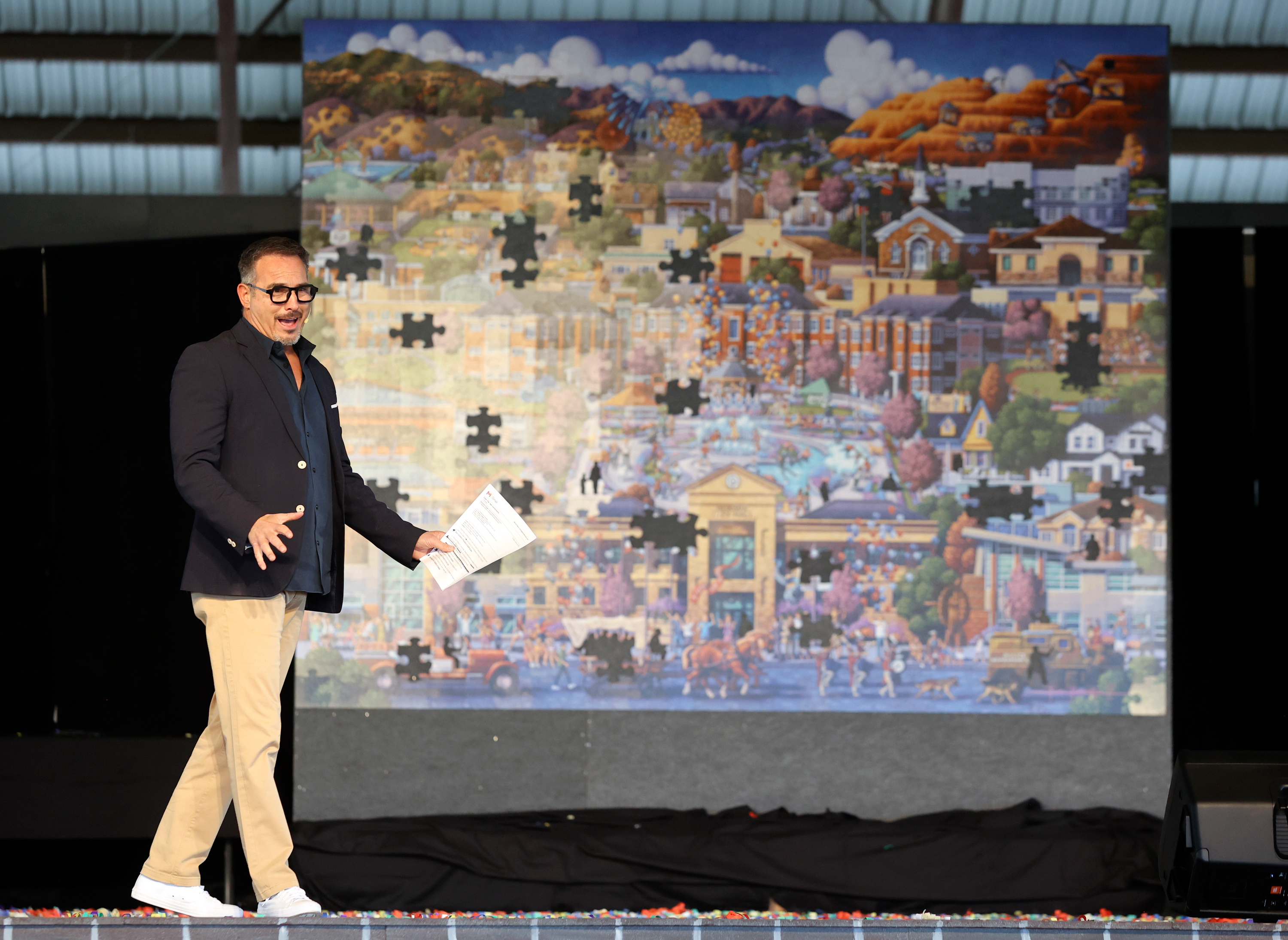 Eric Dowdle speaks after unveiling a giant puzzle he made for Herriman, commissioned by Friends of Herriman and paid for by community sponsors and businesses, at W & M Butterfield Park in Herriman on Saturday.