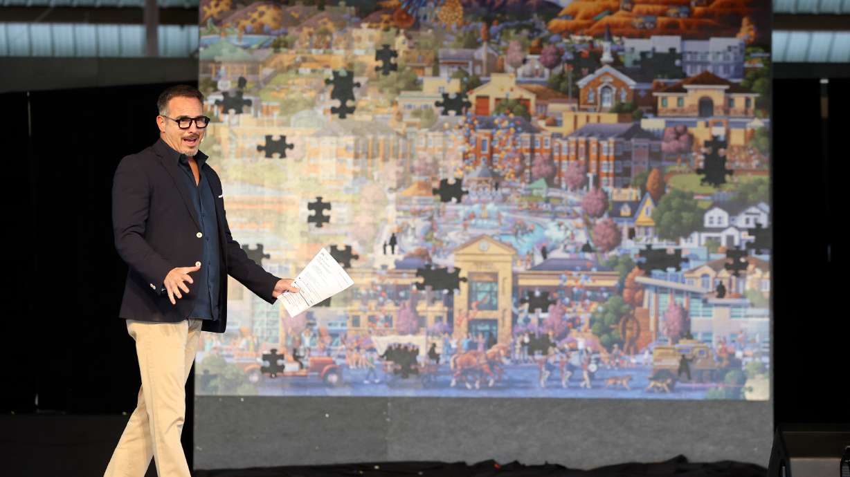 Eric Dowdle speaks after unveiling a giant puzzle he made for Herriman, commissioned by Friends of Herriman and paid for by community sponsors and businesses, at W & M Butterfield Park in Herriman on Saturday.