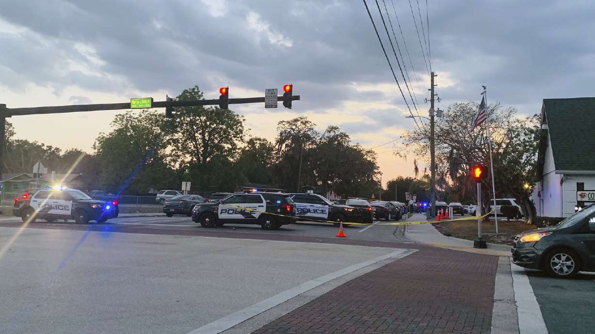 Police units block off 10th Street at Martin Luther King Jr. Avenue on Wednesday after a shooting that wounded a Lakeland officer and a juvenile.