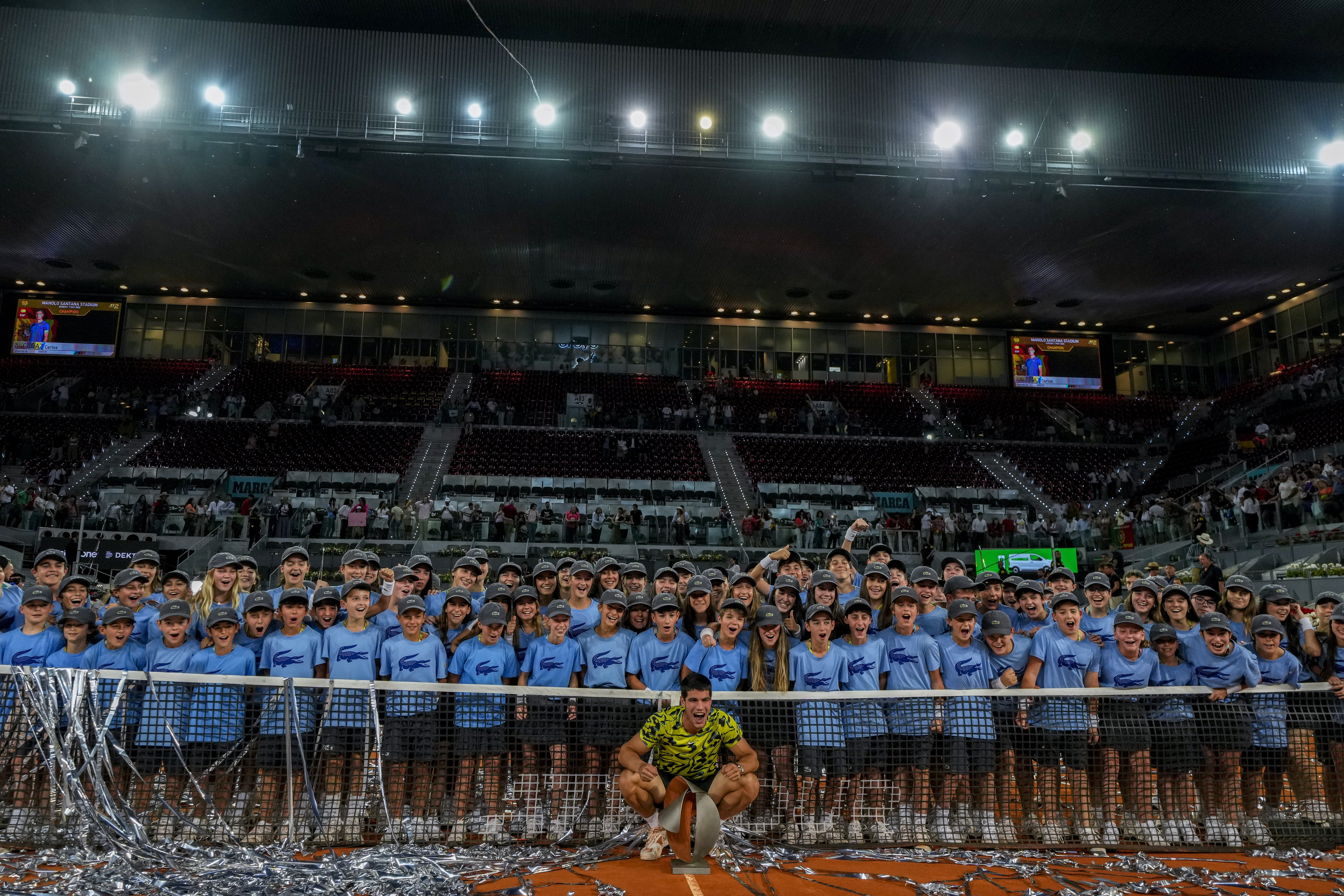 FILE - Carlos Alcaraz, of Spain, poses with the winner's trophy after defeating Jan-Lennard Struff, of Germany, at the end of the men's final at the Madrid Open tennis tournament in Madrid, Spain, Sunday, May 7, 2023. The Madrid Open tennis tournament has issued an apology on Thursday May 11, 2023 for not allowing the women's doubles players to address the crowd following the award's ceremony after the final. The finalists of men's doubles and men's and women's singles were given the chance to speak via microphone to spectators following their matches. 