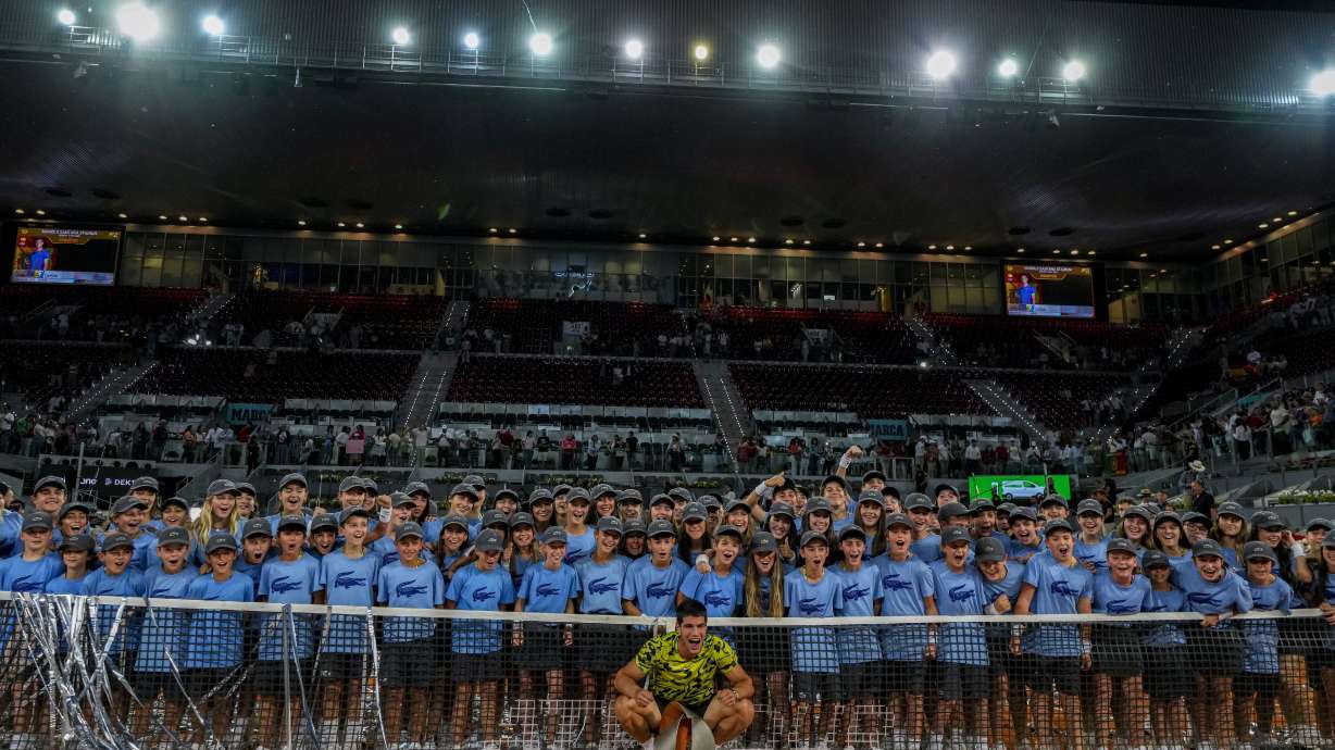 FILE - Carlos Alcaraz, of Spain, poses with the winner's trophy after defeating Jan-Lennard Struff, of Germany, at the end of the men's final at the Madrid Open tennis tournament in Madrid, Spain, Sunday, May 7, 2023. The Madrid Open tennis tournament has issued an apology on Thursday May 11, 2023 for not allowing the women's doubles players to address the crowd following the award's ceremony after the final. The finalists of men's doubles and men's and women's singles were given the chance to speak via microphone to spectators following their matches.
