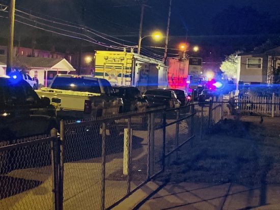 Units from the Lakeland Police Department and Polk County Sheriff's Office line 10th Street in Lakeland, Fla., on Wednesday evening after a shooting incident that wounded a Lakeland police officer and a juvenile.