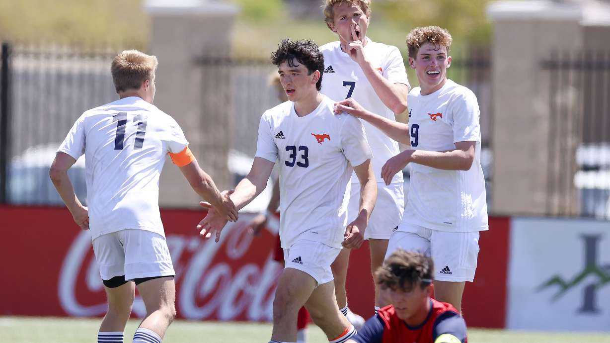 Mountain Crest players congratulate Samuel Hunt (33) for his goal against Crimson Cliffs in the 4A boys soccer state semifinals at Zions Bank Stadium in Herriman on Thursday, May 11, 2023.