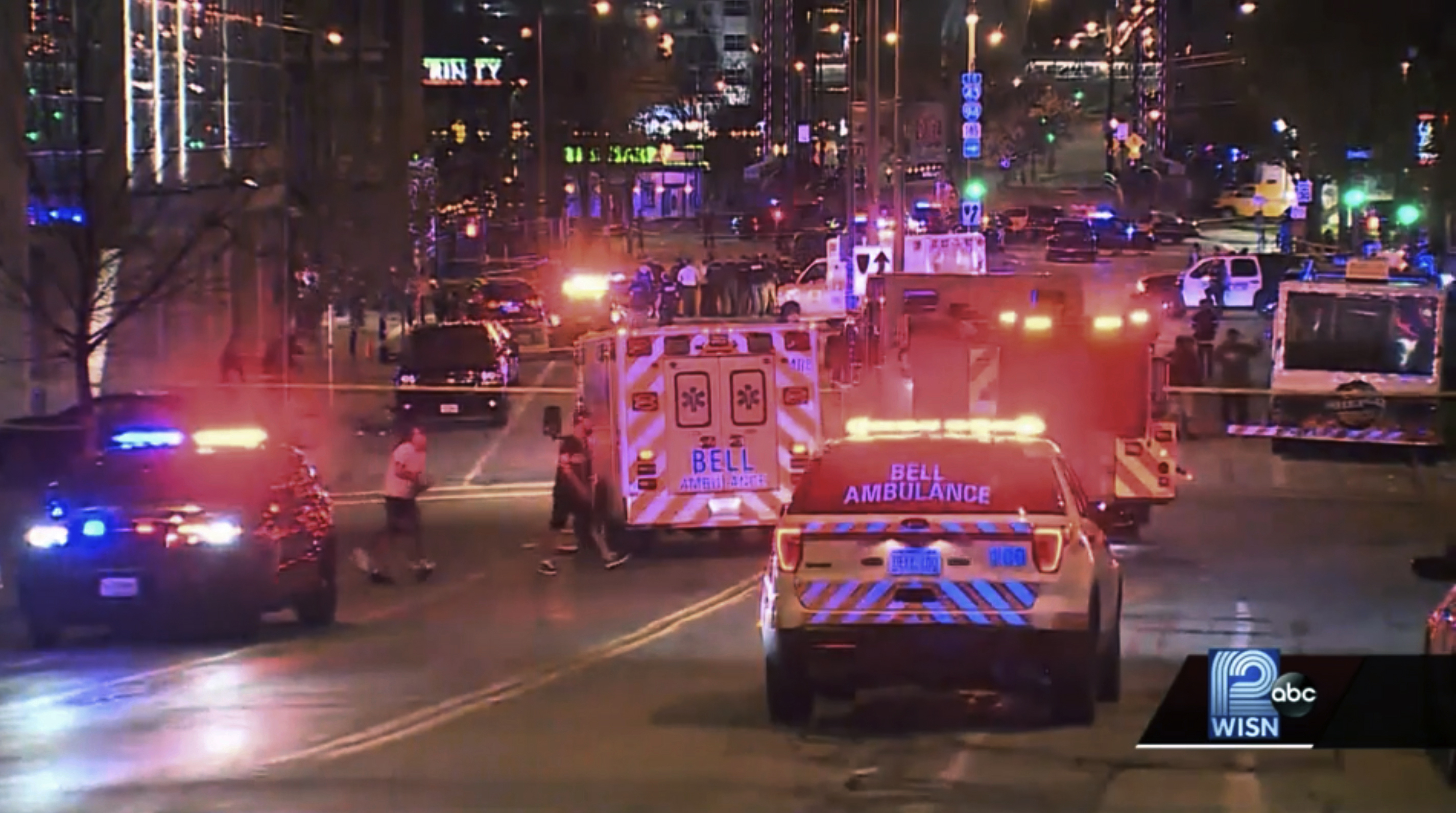 This photo taken from video provided by WISN 12 News shows police responding to the scene of a shooting at Water Street and Juneau Avenue in Milwaukee, Friday, May 13, 2022. Twenty people were injured in two shootings in downtown Milwaukee near an entertainment district where thousands of people were watching the Bucks play the Celtics in the NBA's Eastern Conference semifinals, authorities said. There was no immediate indication whether the two shootings were related or involved fans who were watching the game. 