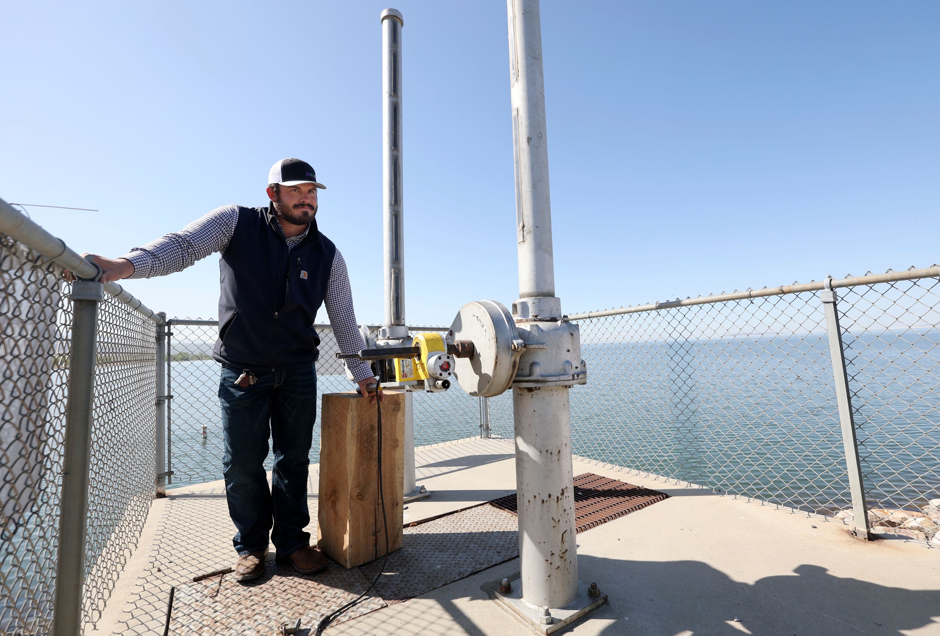 Tracy Hess, Weber Basin Water Conservancy District dam tender, opens the Willard Bay spillway gates for flood mitigation in Box Elder County on Thursday.