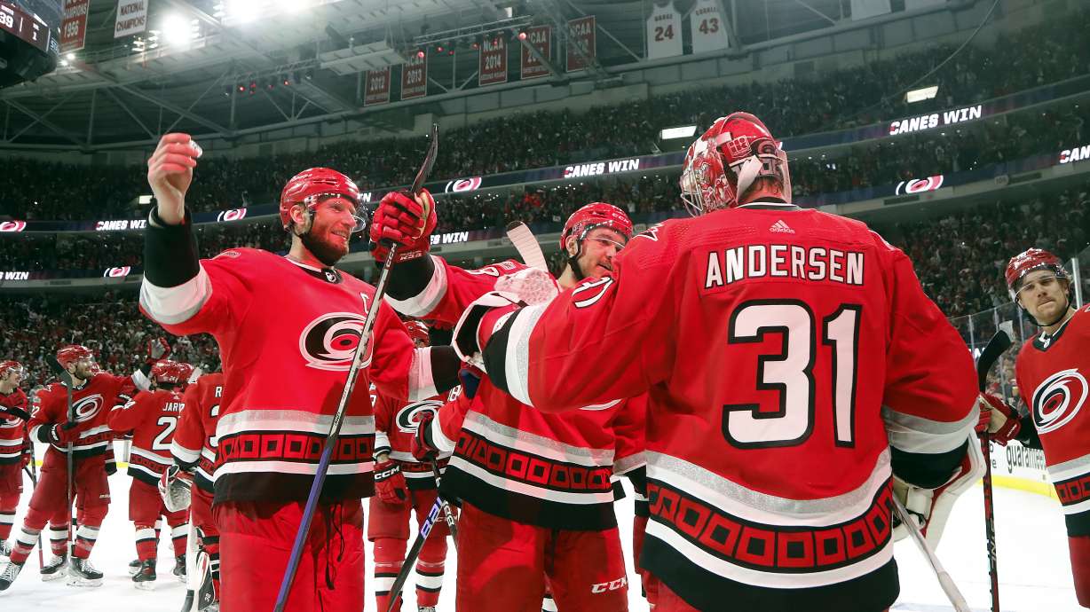 Carolina Hurricanes goaltender Frederik Andersen (31) is congratulated by Jordan Staal, left, and Mackenzie MacEachern, center, on the team's overtime win against the New Jersey Devils in Game 5 of an NHL hockey Stanley Cup second-round playoff series in Raleigh, N.C., Thursday, May 11, 2023.