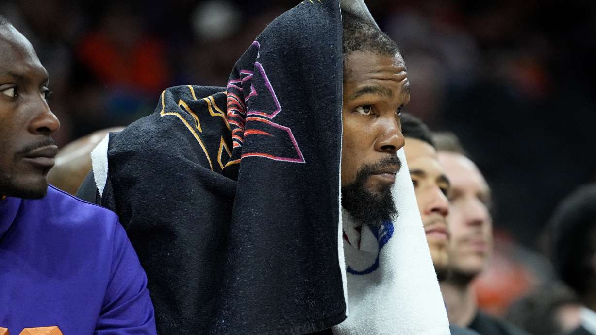 Phoenix Suns forward Kevin Durant watches from the bench during the second half of Game 6 of an NBA basketball Western Conference semifinal series against the Denver Nuggets, Thursday, May 11, 2023, in Phoenix. The Nuggets eliminated the Sun in their 125-100 win.