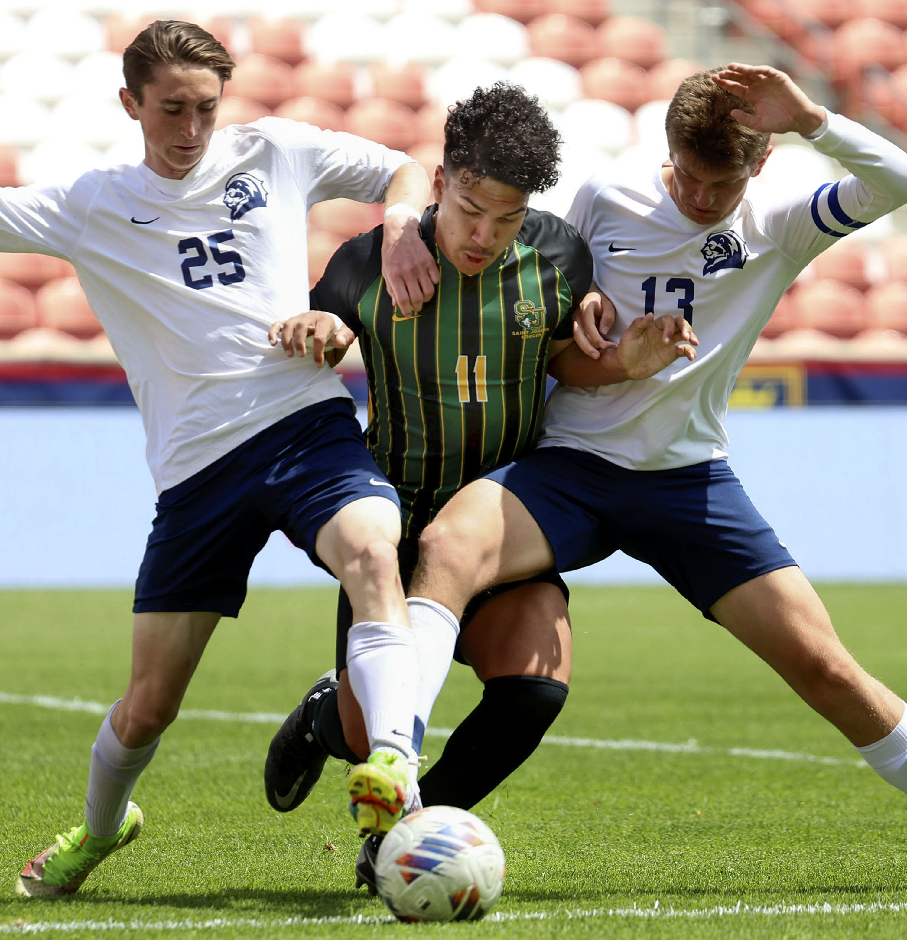 St. Joseph’s Daniel Filho, center, fights for the ball against Maeser Prep’s Sean Babcock (25) and Robert Lane (13) in the 2A boys soccer state championship game at America First Field in Sandy on Friday, May 12, 2023.
