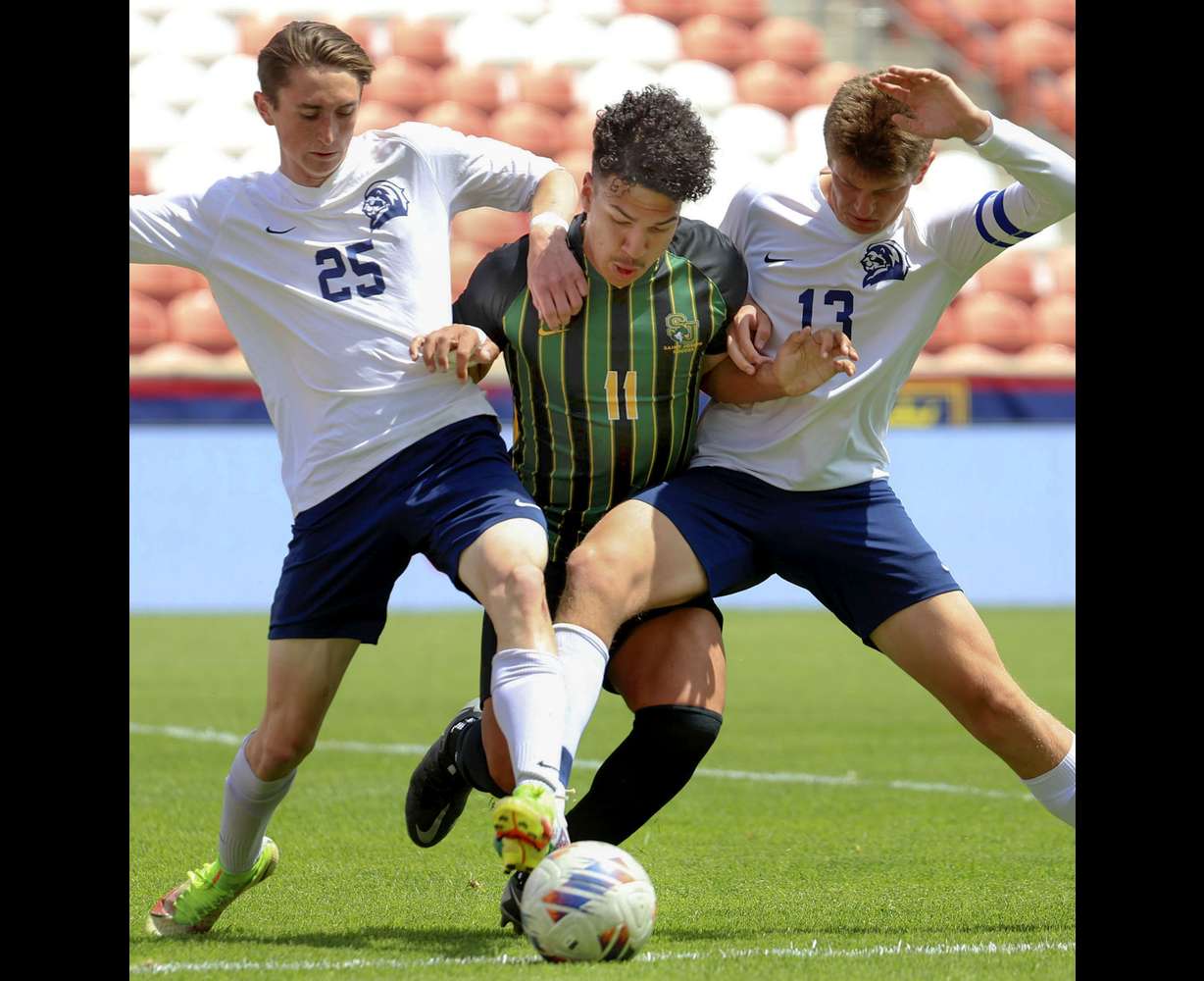 St. Joseph’s Daniel Filho, center, fights for the ball against Maeser Prep’s Sean Babcock (25) and Robert Lane (13) in the 2A boys soccer state championship game at America First Field in Sandy on Friday, May 12, 2023.