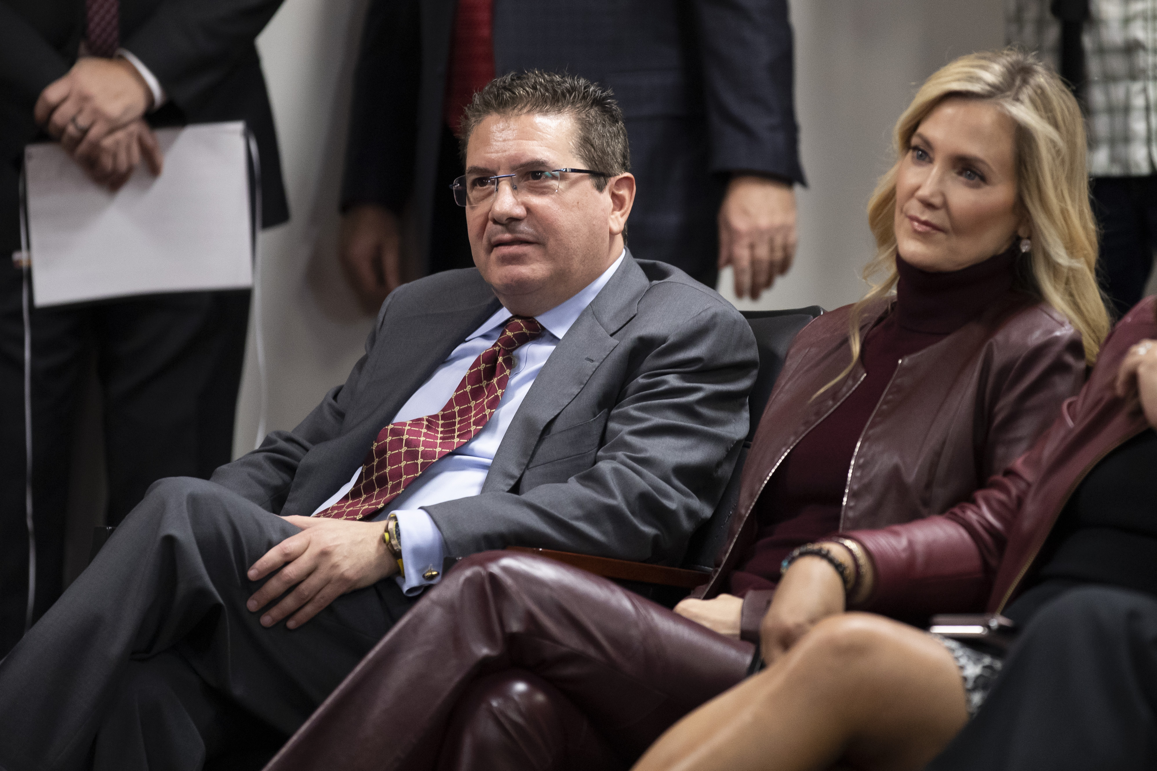 FILE - Washington Redskins owner Dan Snyder, left, and his wife Tanya Snyder, listen to head coach Ron Rivera during a news conference at the team's NFL football training facility in Ashburn, Va., Thursday, Jan. 2, 2020. A group led by Josh Harris and Mitchell Rales that includes Magic Johnson has an agreement in principle to buy the NFL's Washington Commanders from longtime owner Dan Snyder for a North American professional sports team record $6 billion, according to a person with knowledge of the situation. The person spoke to The Associated Press on condition of anonymity Thursday, April 13, 2023, because the deal had not been announced.