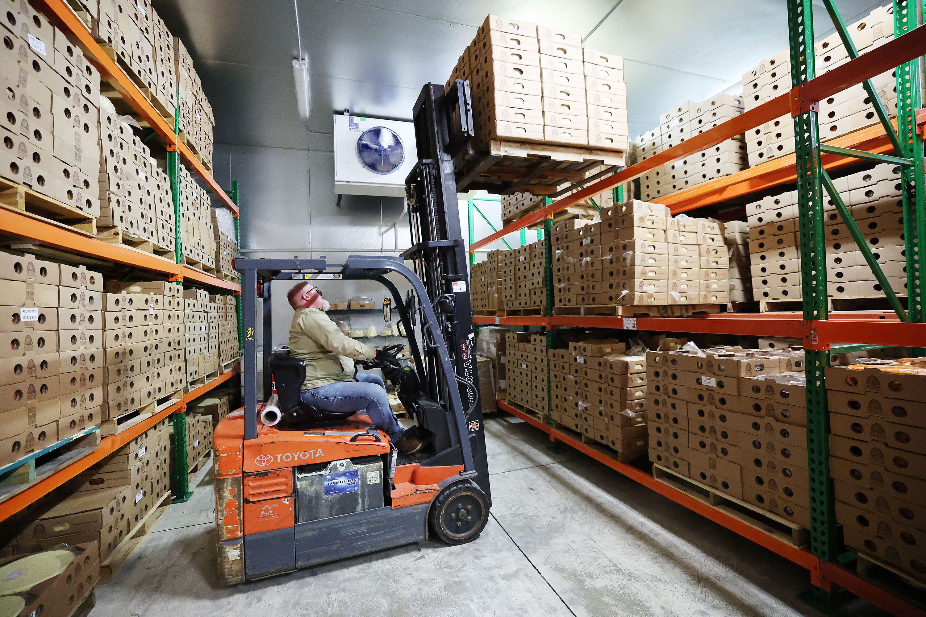 Mike Smith rotates aged cheese at Beehive Cheese, a second generation family-owned business, in Uintah, Weber County, on May 2.