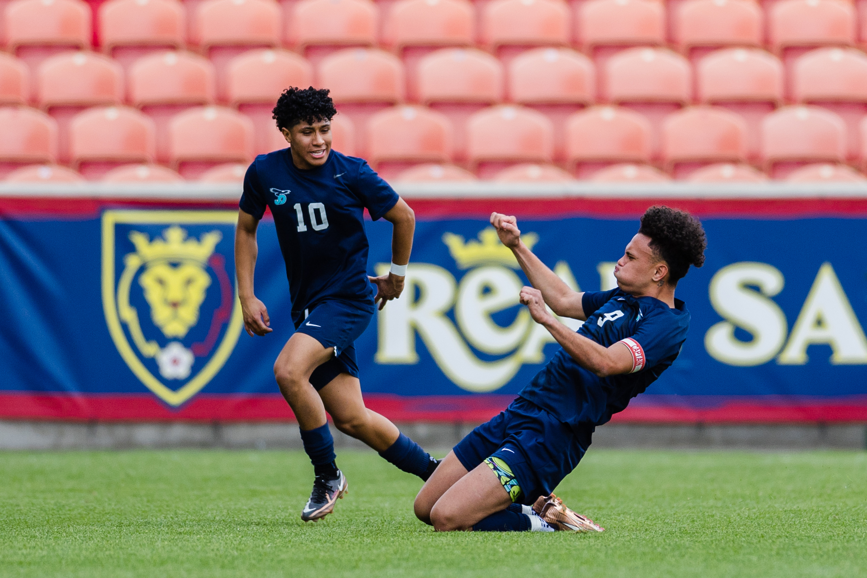 Juan Diego Catholic’s Hauroa Margant (9) celebrates with teammate Danny Gutierrez (10) after scoring on a free kick during the 3A boys baseball quarterfinals at America First Field in Sandy on May 12, 2023.