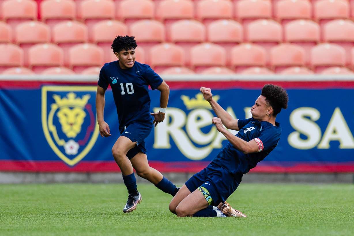 Juan Diego Catholic’s Hauroa Margant (9) celebrates with teammate Danny Gutierrez (10) after scoring on a free kick during the 3A boys baseball quarterfinals at America First Field in Sandy on May 12, 2023.