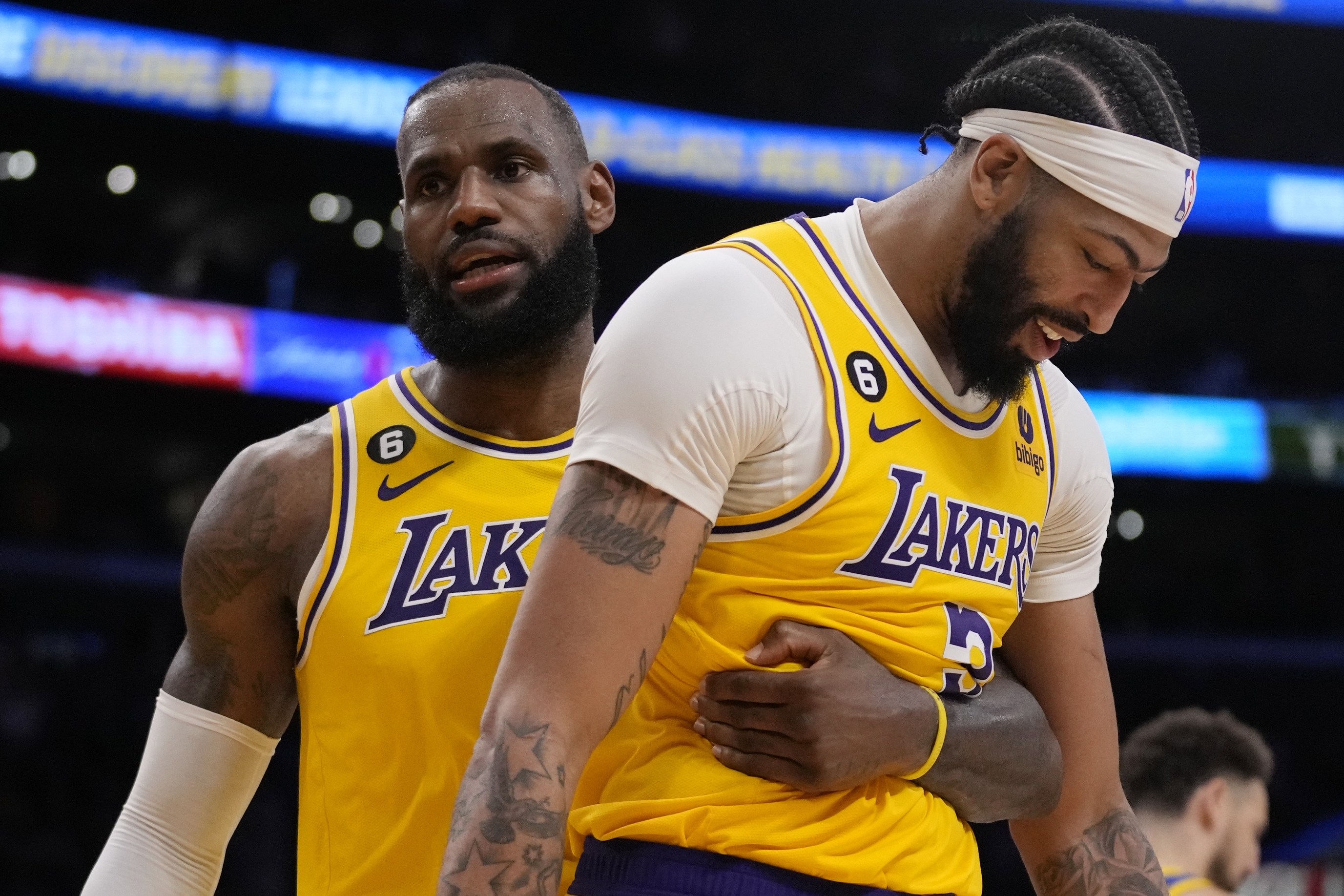 Los Angeles Lakers forward LeBron James, left, hugs forward Anthony Davis during the second half in Game 6 of an NBA basketball Western Conference semifinal series against the Golden State Warriors Friday, May 12, 2023, in Los Angeles.
